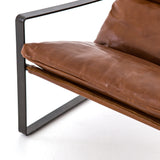 Featuring Emmett Sling Chair - Leather by Four Hands at Amethyst Home. Super stylish, effortlessly cool. Sling-style seating of tobacco-toned leather sits low and curved for a fresh take on a throwback form. Slim, gunmetal-finished iron framing ups the drama factor of an innately hip design.
Overall Dimensions: 29"W x 36"L x 29"HColors: Dakota Tobacco, .  Amethyst Home provides interior design, new home construction design consulting, vintage area rugs, and lighting in the Laguna Beach metro area.