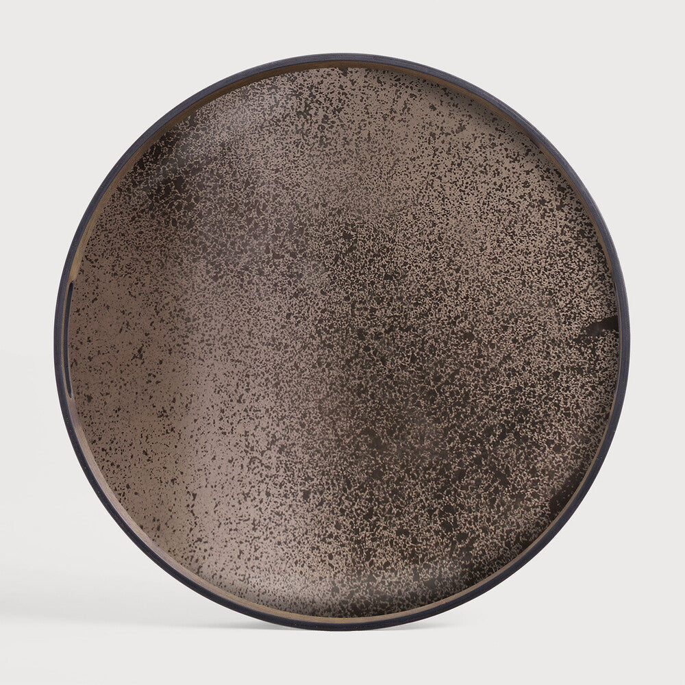 Featuring Bronze Mirror Tray by Ethnicraft at Amethyst Home. A subdued color palette meets captivating motifs inspired by nature and travel. This bronze mirror tray experiments with the balance between rich patterns offset with muted tones, revealing the beauty behind the deceivingly ordinary subjects from which inspiration is drawn. In doing so, this collection captures the essence of time. Amethyst Home provides interior design services, furniture, rugs, and lighting in the Charlotte metro area.