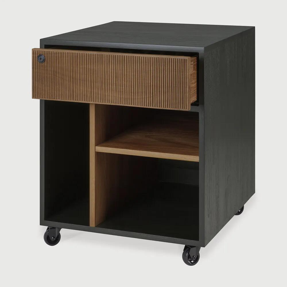 Featuring Oscar Drawer Unit Teak black by Ethnicraft at Amethyst Home. Bringing form and function to your professional way of life, the Oscar collection ticks the right boxes. Featuring hand-carved details in solid teak and the practicality of wheels, the Oscar drawer unit can serve many purposes, fitting perfectly under a desk for extra storage or as a standa. Amethyst Home provides interior design, new home construction design consulting, vintage area rugs, and lighting in the Boston metro area.