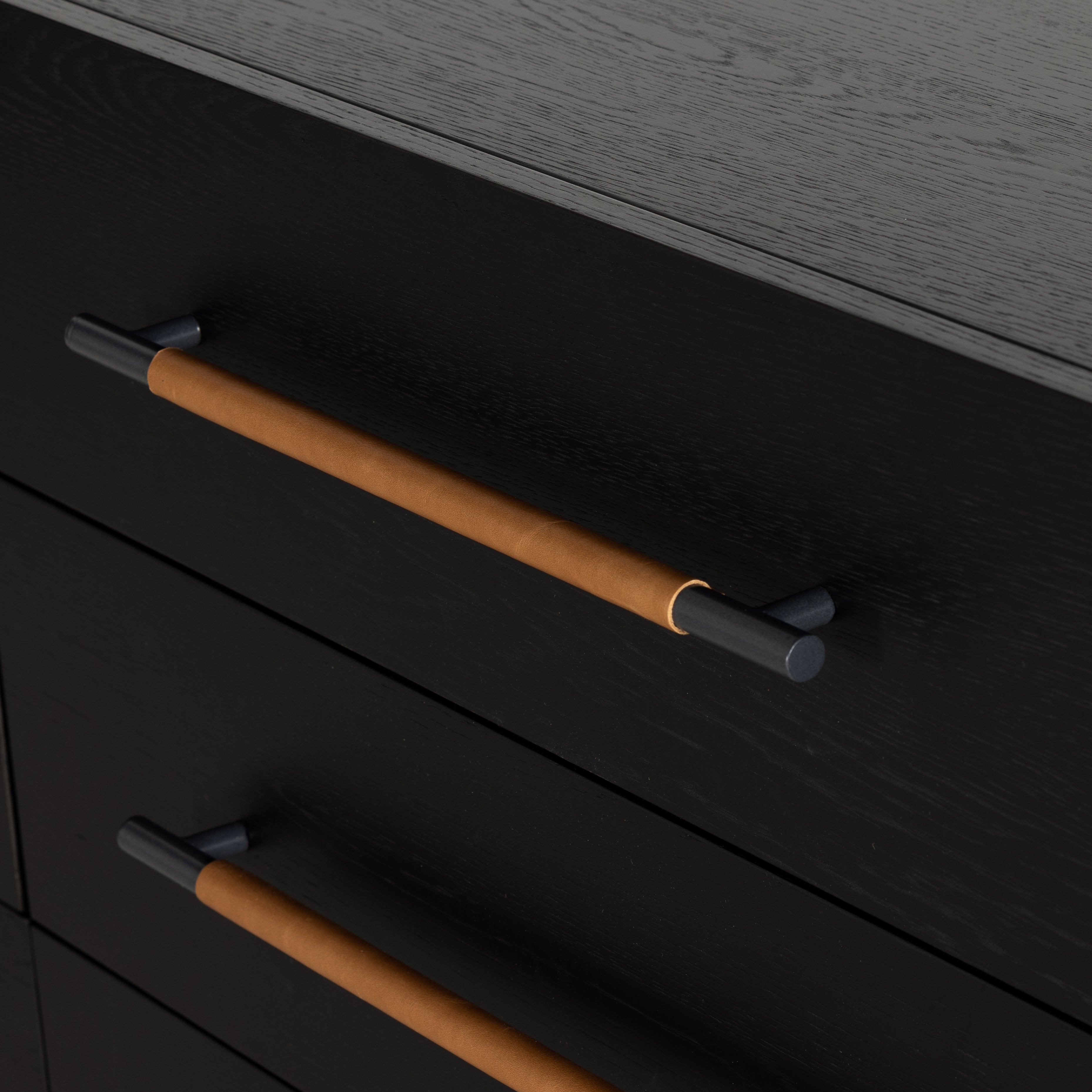 Featuring Rosedale Ebony Oak 6 Drawer Dresser by Four Hands at Amethyst Home. The ebony oak of this Rosedale 6 Drawer Dresser brings a moody, darkness to any room. With six spacious drawers and iron hardware wrapped in a gorgeous, tan leather, this is a functional and beautiful piece to add to your bedroom or other area. 
Overall Dimensions: 62.50"W x 19.5. Amethyst Home provides interior design, new home construction design consulting, vintage area rugs, and lighting in the Washington metro area.