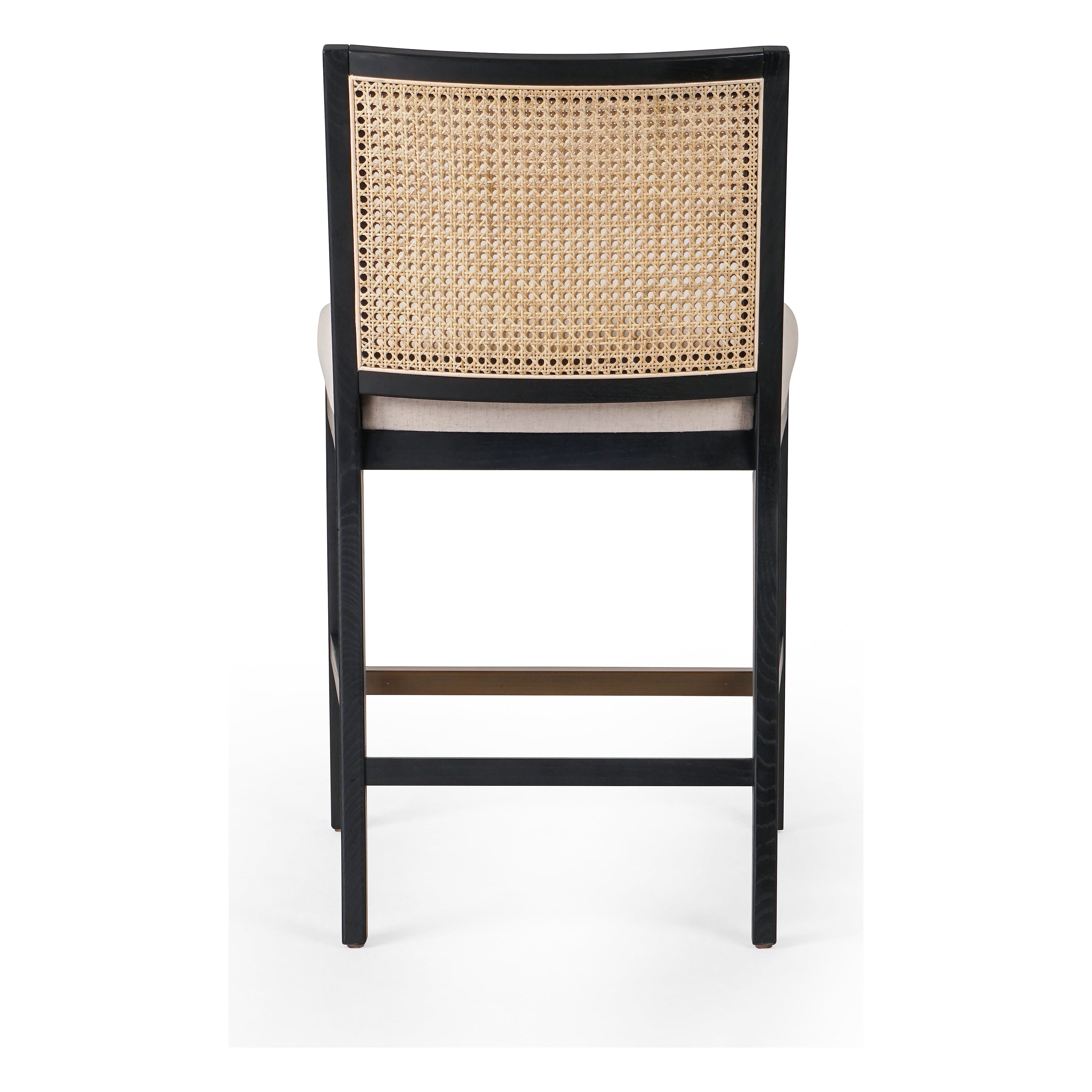 Featuring Antonia  Armless Dining Stool Stool by Four Hands at Amethyst Home. Light-toasted parawood frames a textural inlay of natural cane for a clean, monochromatic look, with seating of performance fabric for smart sensibility. Perfectly sized for the counter, with a brass kick plate for comfort and contrast. Performance fabrics are specially created to withstand spills, stains. Amethyst Home provides interior design, new construction, custom furniture, and area rugs in the Houston metro area.