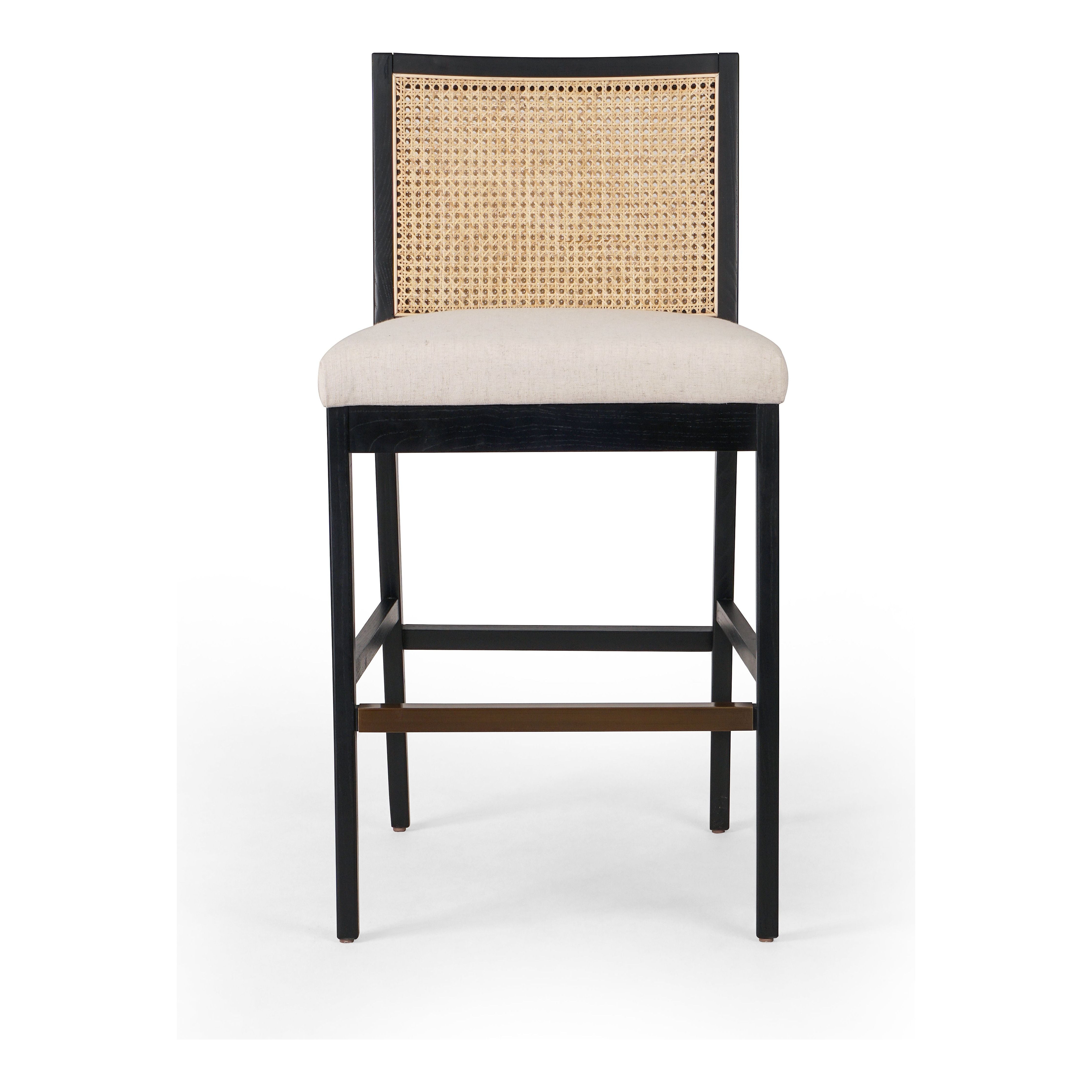 Featuring Antonia  Armless Dining Stool Stool by Four Hands at Amethyst Home. Light-toasted parawood frames a textural inlay of natural cane for a clean, monochromatic look, with seating of performance fabric for smart sensibility. Perfectly sized for the counter, with a brass kick plate for comfort and contrast. Performance fabrics are specially created to withstand spills, st. Amethyst Home provides interior design, new construction, custom furniture, and area rugs in the Los Angeles metro area.