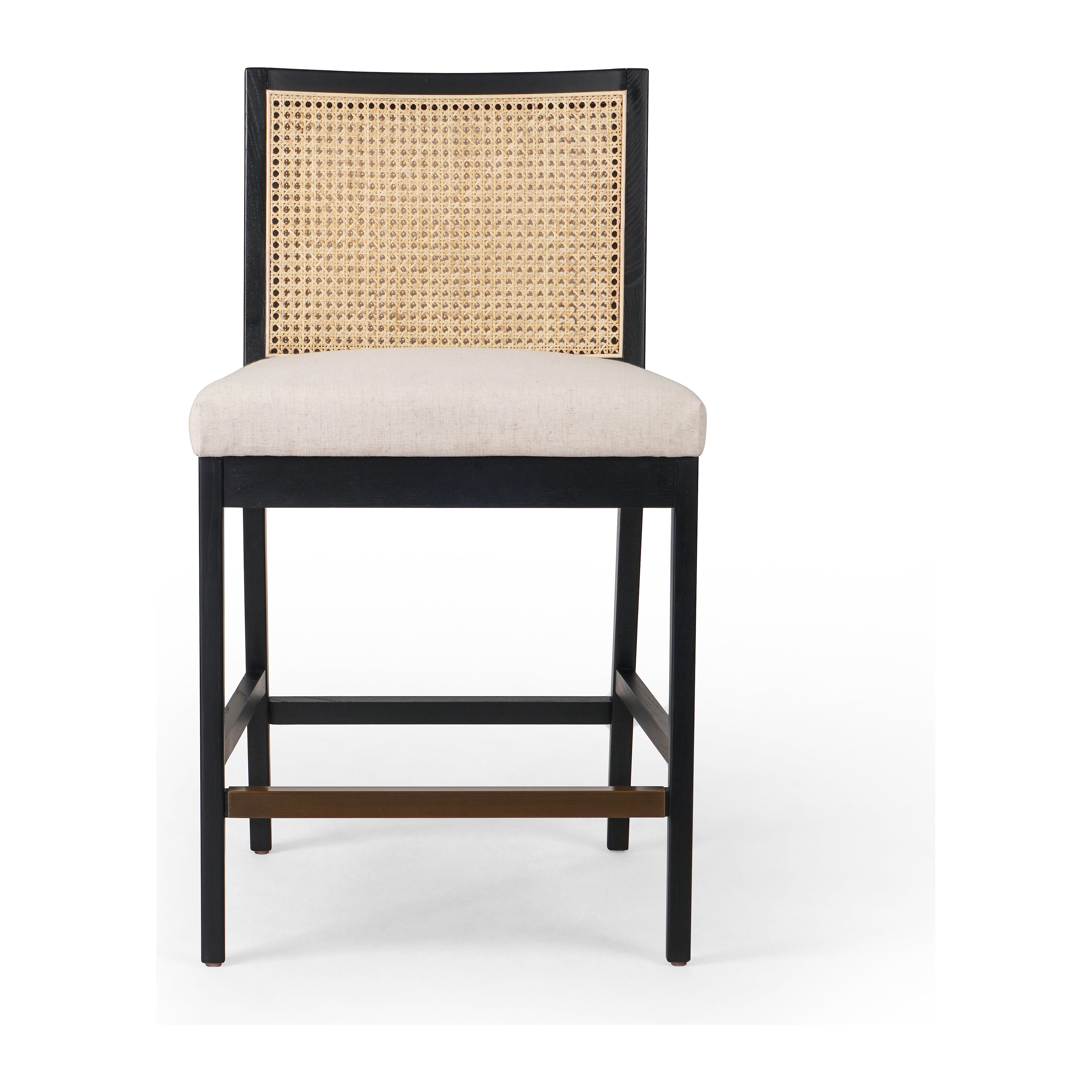 Featuring Antonia  Armless Dining Stool Stool by Four Hands at Amethyst Home. Light-toasted parawood frames a textural inlay of natural cane for a clean, monochromatic look, with seating of performance fabric for smart sensibility. Perfectly sized for the counter, with a brass kick plate for comfort and contrast. Performance fabrics are specially created to withstand spills, stains, . Amethyst Home provides interior design, new construction, custom furniture, and area rugs in the Omaha metro area.