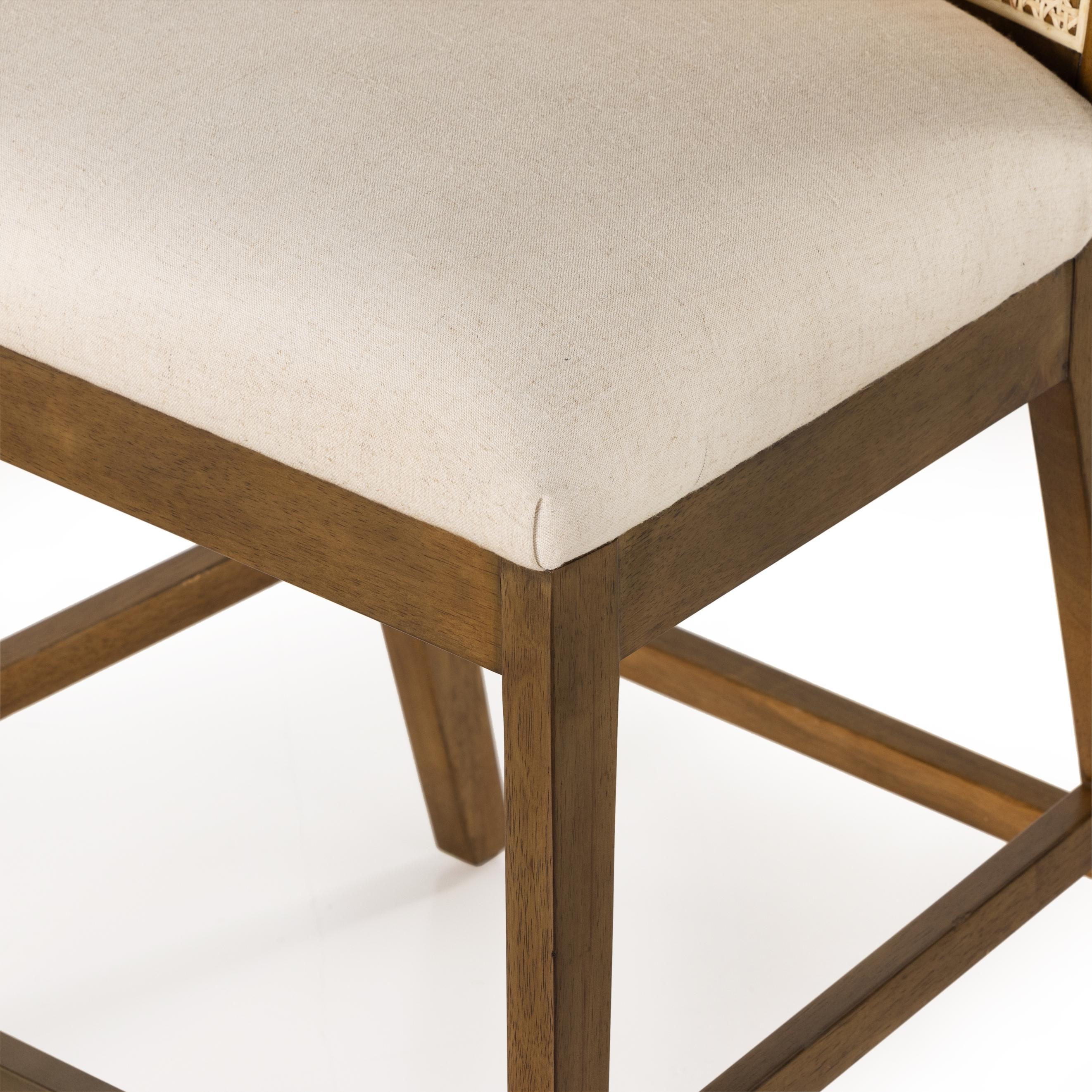 Featuring Antonia Solid Parawood Cane Armless Stool by Four Hands at Amethyst Home. Mixed materials refresh retro stool seating. Light-toasted nettlewood frames a textural inlay of natural cane for a clean, monochromatic look, with a light, linen-blend seat of high-performance fabric brings smart sensibility to bar-style seating. Performance fabrics are special. Amethyst Home provides interior design, new home construction design consulting, vintage area rugs, and lighting in the Omaha metro area.