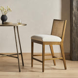 Featuring Antonia Solid Parawood Cane Armless Stool by Four Hands at Amethyst Home. Mixed materials refresh retro stool seating. Light-toasted nettlewood frames a textural inlay of natural cane for a clean, monochromatic look, with a light, linen-blend seat of high-performance fabric brings smart sensibility to bar-style seating. Performance fabrics are spe. Amethyst Home provides interior design, new home construction design consulting, vintage area rugs, and lighting in the Park City metro area.