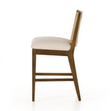 Featuring Antonia Solid Parawood Cane Armless Stool by Four Hands at Amethyst Home. Mixed materials refresh retro stool seating. Light-toasted nettlewood frames a textural inlay of natural cane for a clean, monochromatic look, with a light, linen-blend seat of high-performance fabric brings smart sensibility to bar-style seating. Performance fabrics are spe. Amethyst Home provides interior design, new home construction design consulting, vintage area rugs, and lighting in the San Diego metro area.