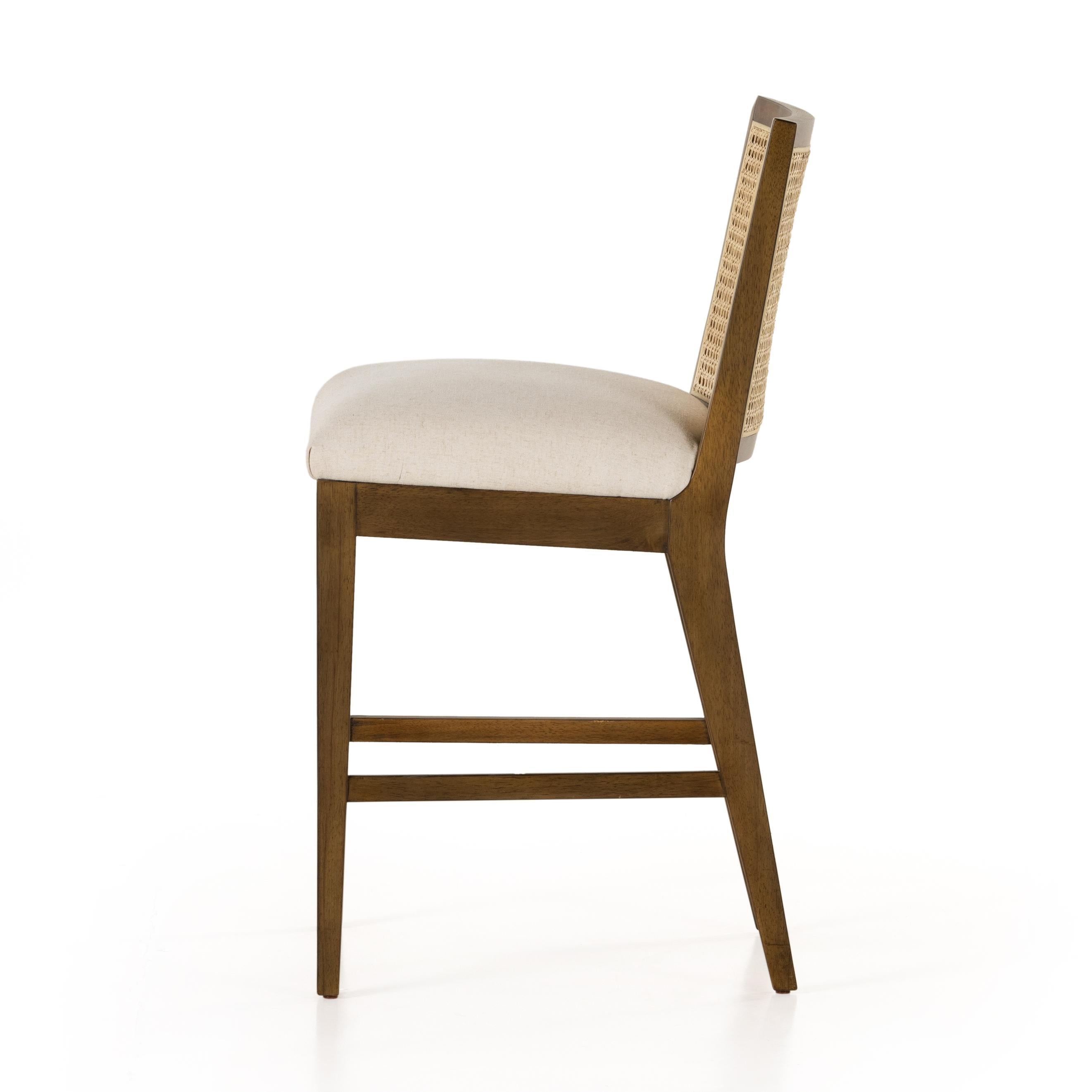 Featuring Antonia Solid Parawood Cane Armless Stool by Four Hands at Amethyst Home. Mixed materials refresh retro stool seating. Light-toasted nettlewood frames a textural inlay of natural cane for a clean, monochromatic look, with a light, linen-blend seat of high-performance fabric brings smart sensibility to bar-style seating. Performance fabrics are spe. Amethyst Home provides interior design, new home construction design consulting, vintage area rugs, and lighting in the San Diego metro area.