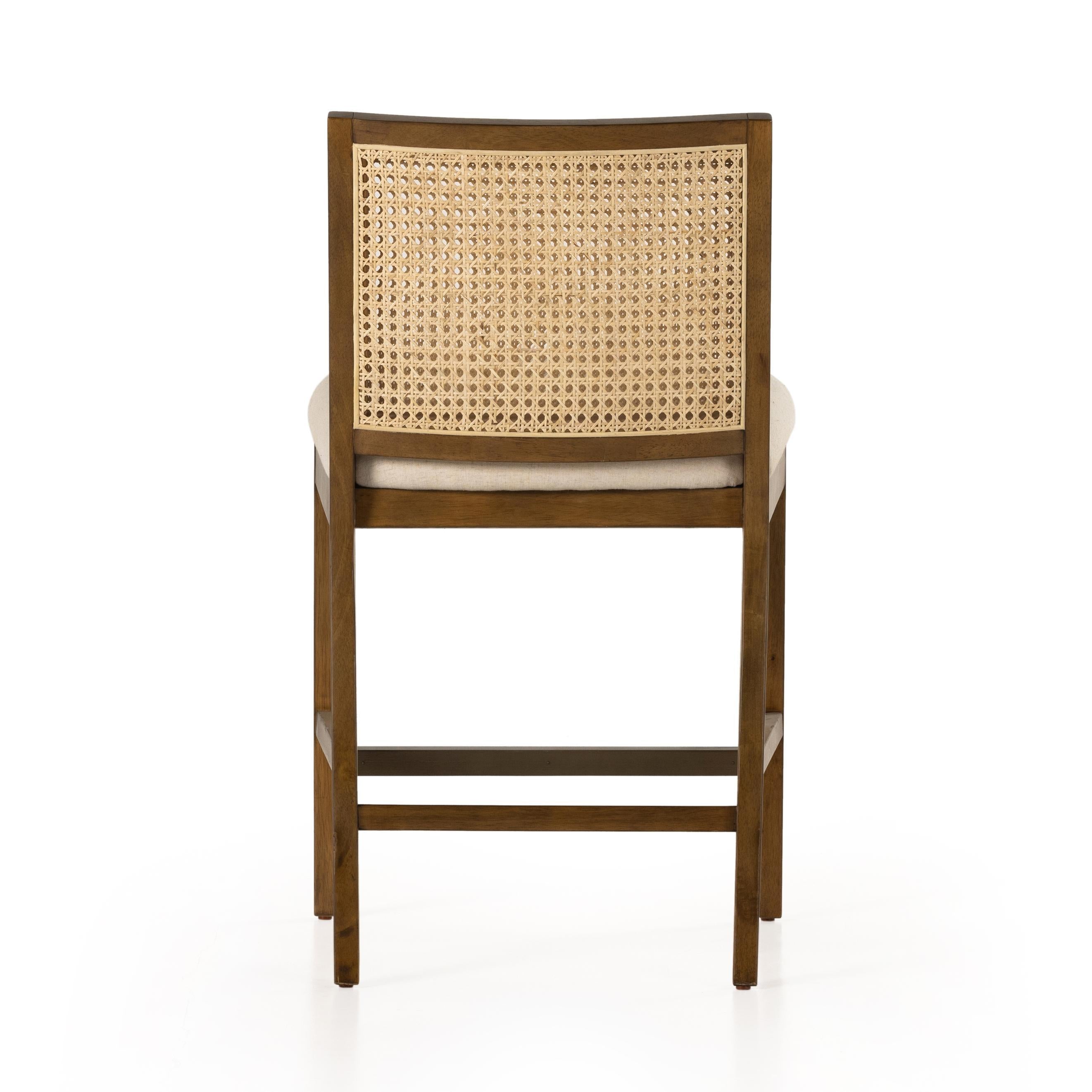 Featuring Antonia Solid Parawood Cane Armless Stool by Four Hands at Amethyst Home. Mixed materials refresh retro stool seating. Light-toasted nettlewood frames a textural inlay of natural cane for a clean, monochromatic look, with a light, linen-blend seat of high-performance fabric brings smart sensibility to bar-style seating. Performance fabrics are special. Amethyst Home provides interior design, new home construction design consulting, vintage area rugs, and lighting in the Tampa metro area.