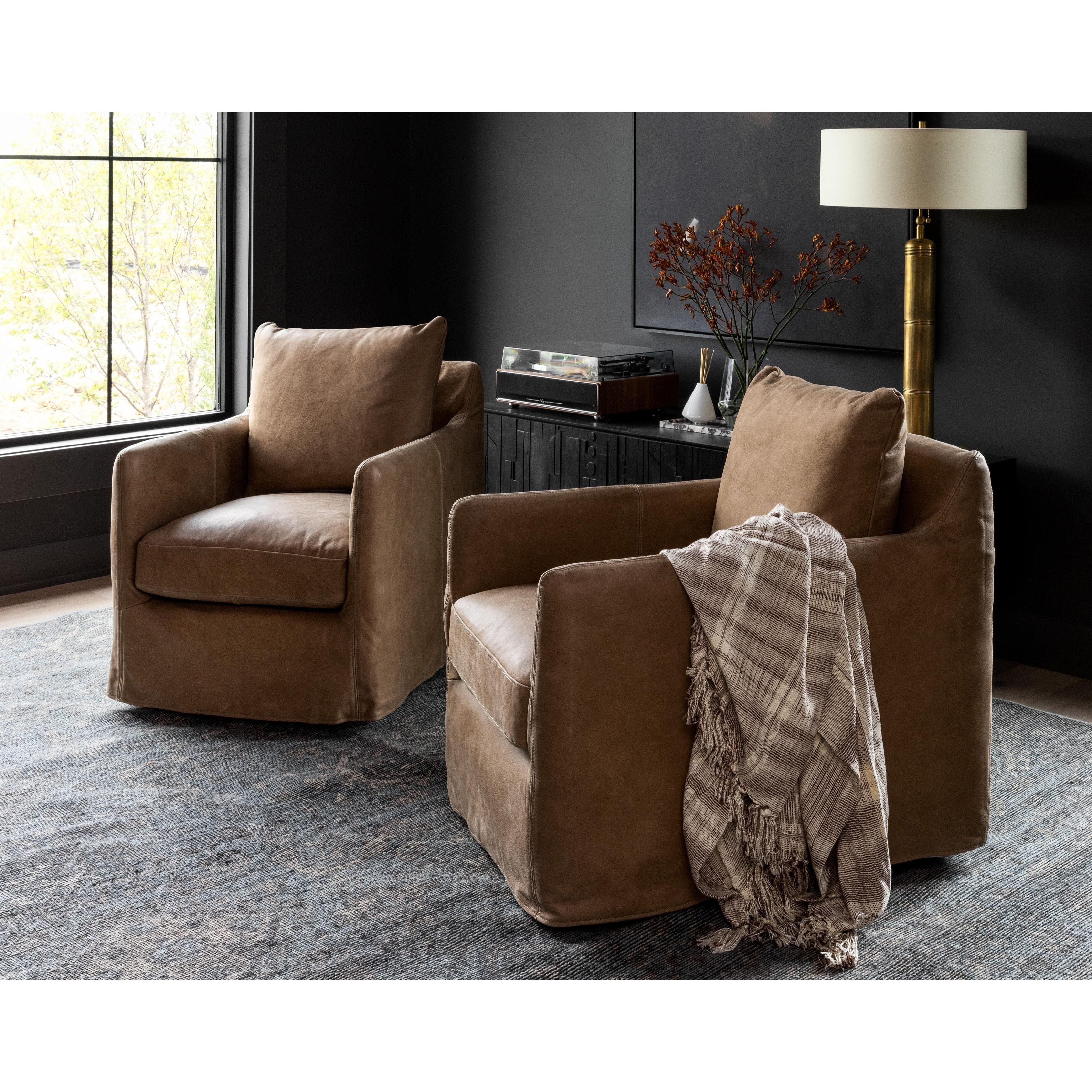 Featuring Freddy Leather Swivel Chair by Four Hands at Amethyst Home. The Freddy Leather Swivel Chair is a slipcovered, leather swivel chair -- perfect for moody rooms. The chair features a comfortable, plush back and supportive seat. Please expect natural distressing.
Overall Dimensions: 27"W x 35.50"L x 32.75"HSeat Depth: 20"Seat Height: 18"Arm Height from.  Amethyst Home provides interior design, new home construction design consulting, vintage area rugs, and lighting in the Seattle metro area.