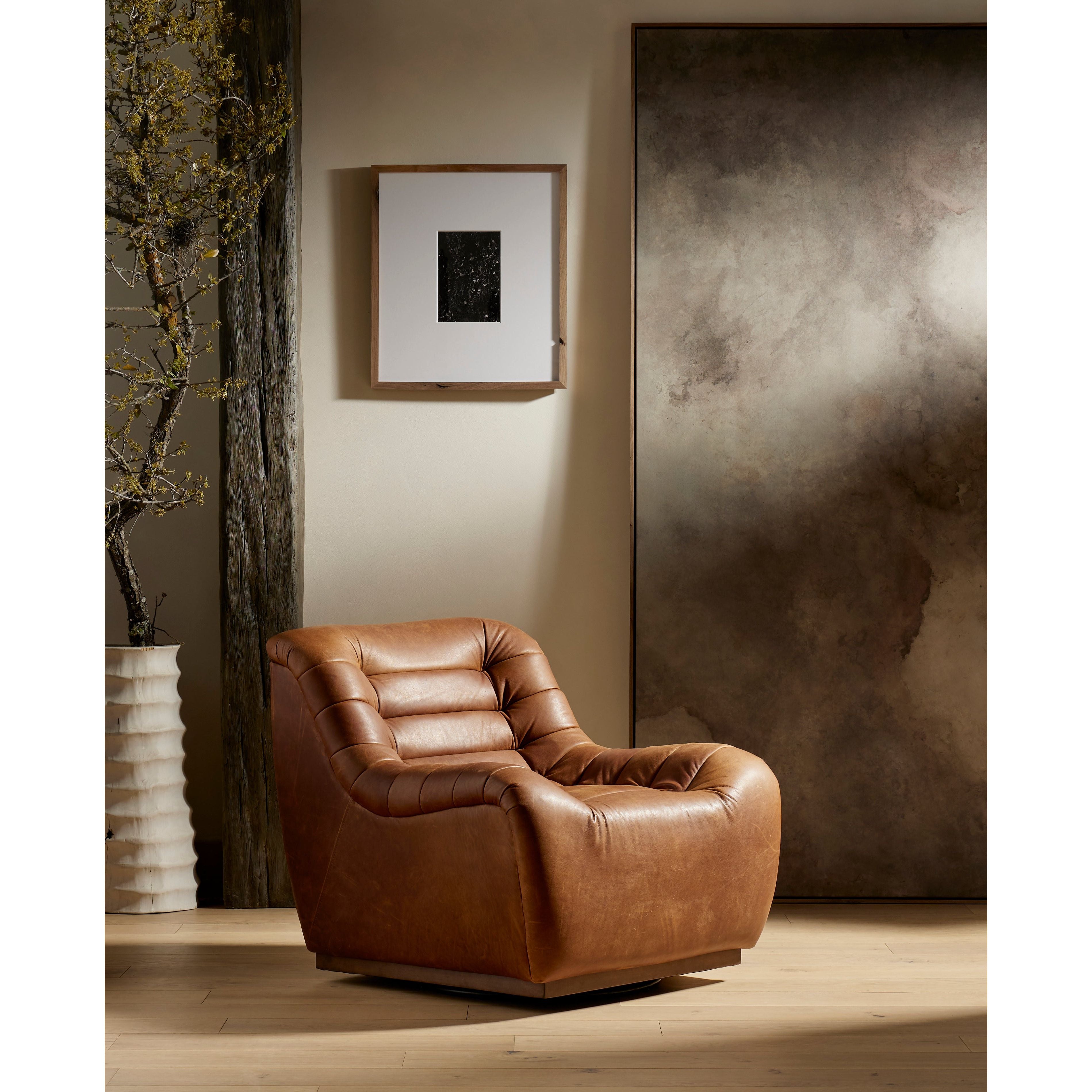 Featuring Binx Heirloom Sienna Swivel Chair by Four Hands at Amethyst Home. Tightly tailored top-grain leather and horizontal channeling make a major statement that's fun and sophisticated alike. A 360-degree plinth swivel adds makes it modern. The Binx Heirloom Sienna Swivel Chair is salvaged and processed from upcycled hides featuring an abundance of natural markings, scars, and color variations. Amethyst Home provides interior design services, furniture, rugs, and lighting in Dallas metro area.