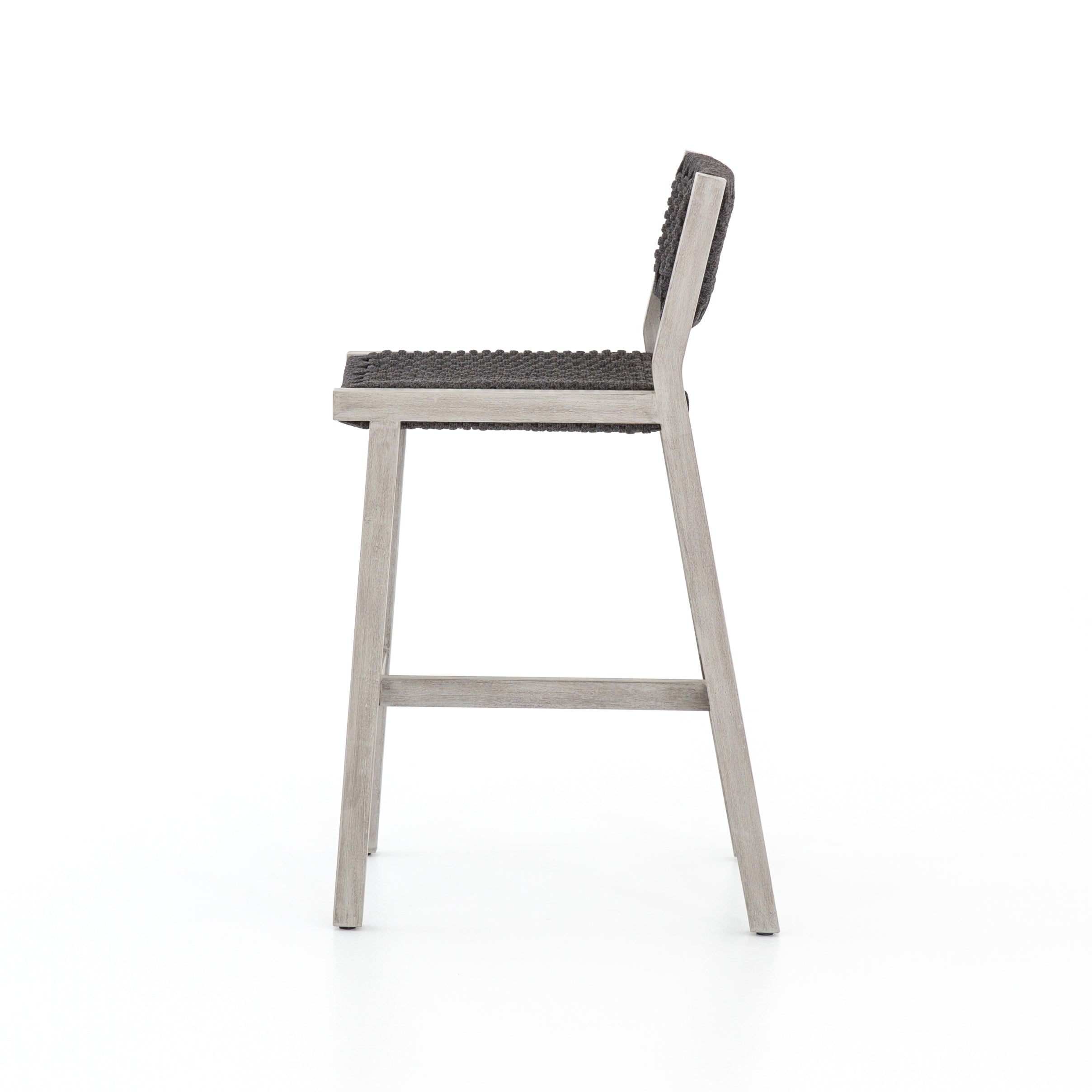 Featuring Delano Grey Outdoor Bar Stool by Four Hands at Amethyst Home. A textural take on outdoor bar styling, weathered grey teak welcomes thick, handwoven rope seating in an inviting grey. Safe for outdoor spaces. Cover or store indoors during inclement weather and when not in use.Overall Dimensions: 19.75"W x 24"L x 40.50"H
Collection: SolanoColors: Thick Dark Grey Rope ,Wea. Amethyst Home provides interior design, new construction, custom furniture, and area rugs in the Washington metro area.