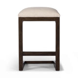 Featuring Finn Sienna Brown Oak Counter Stool by Four Hands at Amethyst Home. A stunner from every angle, this architecturally inspired stool features an angular base crafted from solid oak with two iron rods for added support and visual interest. Seat is upholstered in a linen/cotton/poly blend performance fabric with subtle texture throughout. Performance. Amethyst Home provides interior design, new home construction design consulting, vintage area rugs, and lighting in the Nashville metro area.