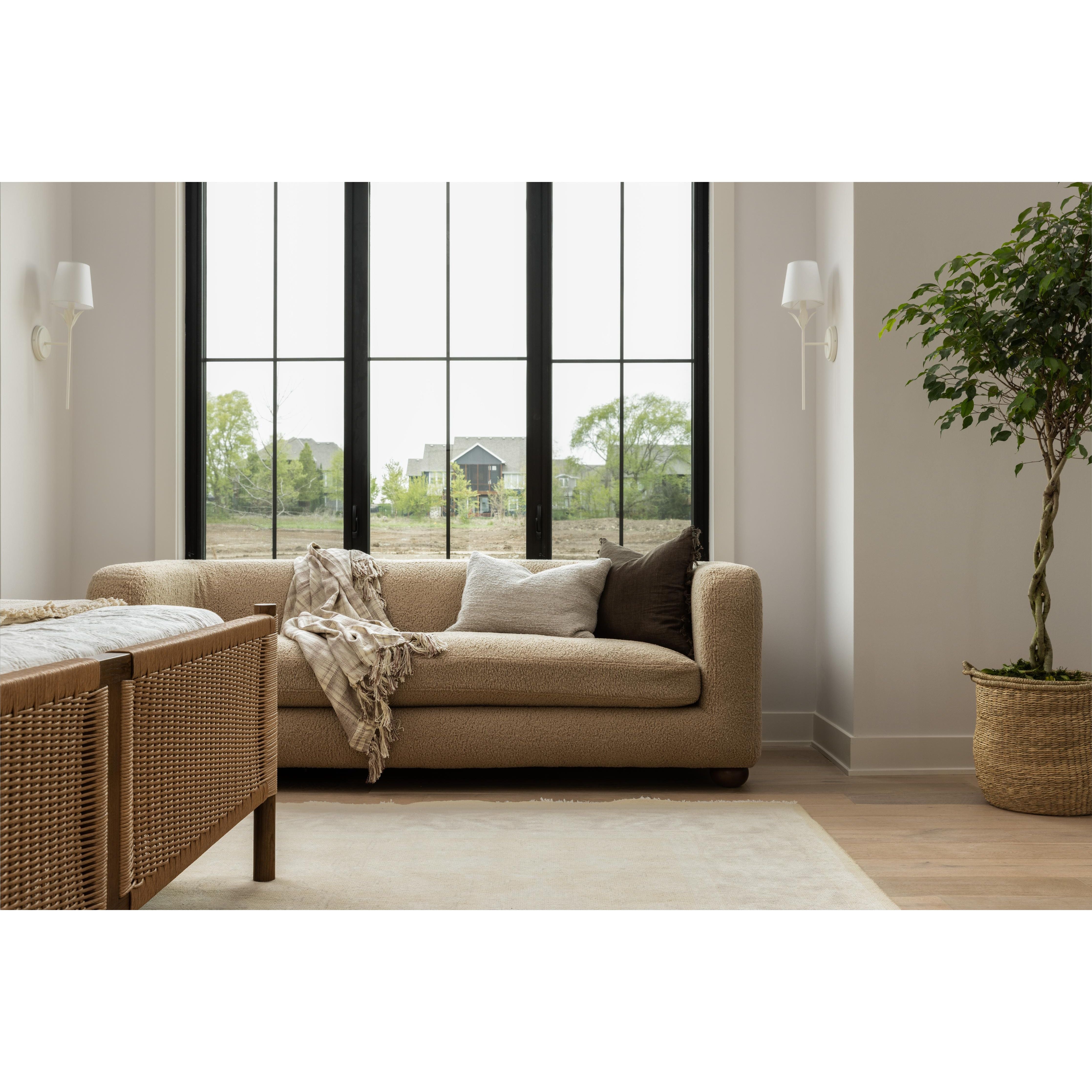 The Gidget Sheepskin Camel Sofa is a stylish and comfortable addition to any home. The bench-seat cushioning and feather-blend seating ensure total comfort for lounging and relaxing. This piece can be paired with a variety of home decor styles, from modern coastal to traditional. Perfectly complemented by white plaster lighting and a Turkish oushak rug. Ideal for Nashville, Florida, and Utah home designs.