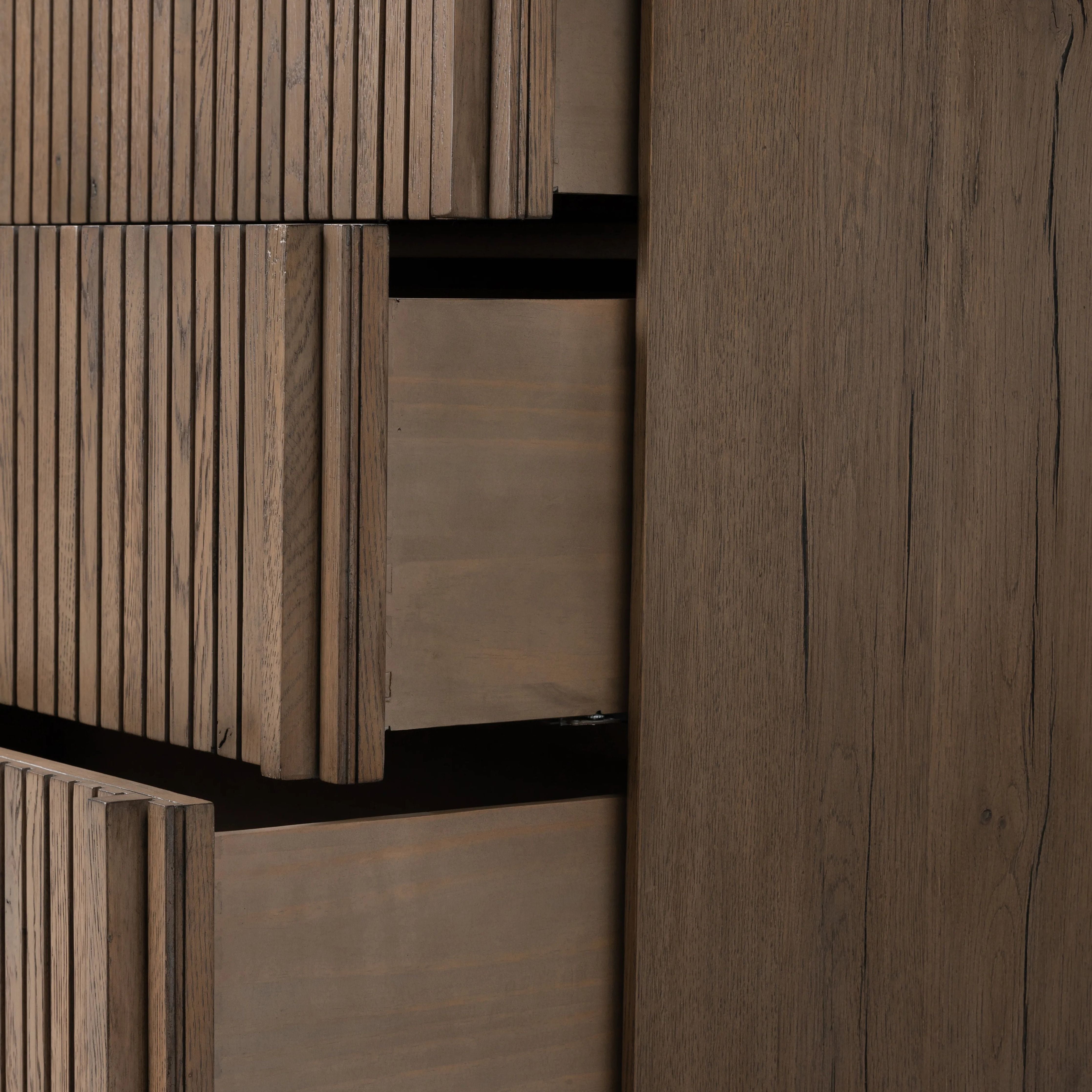 Featuring Leo Rustic Grey 6 Drawer Dresser by Four Hands at Amethyst Home. Designed by Thomas Bina and Ronald Sasson, a design partnership blending both modern minimalist and Brazilian influences. Crafted from solid oak, this clean-lined dresser features vertical reed detailing on the drawer fronts with wooden pull detailing on the outer edges. Drawers are fini. Amethyst Home provides interior design, new home construction design consulting, vintage area rugs, and lighting in the Tampa metro area.