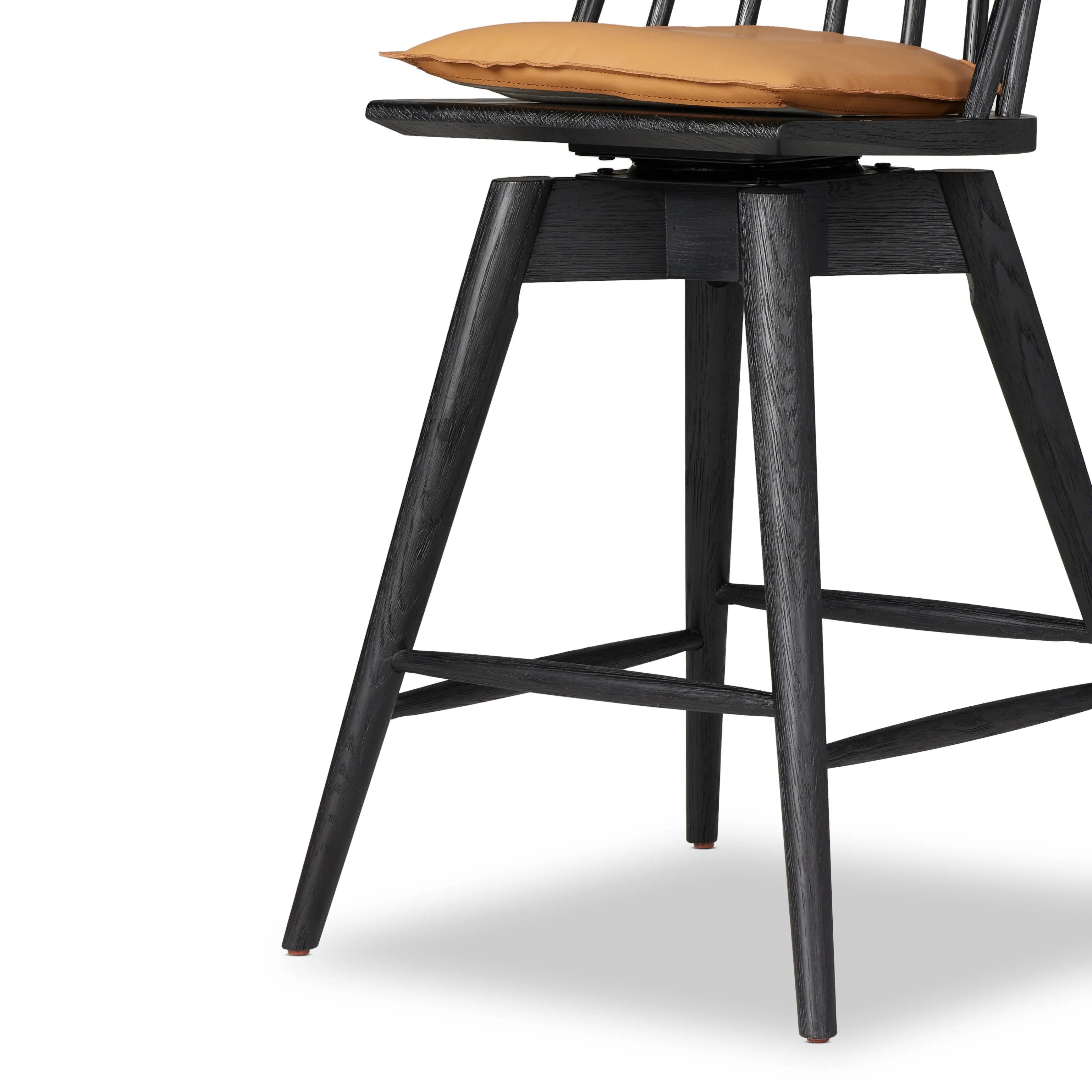 Featuring Lewis Black Counter Swivel Stool with Cushion by Four Hands at Amethyst Home. A new take on the traditional Windsor. This tall beauty is wire-brushed to highlight the cathedral grain of black oak. Perfectly sized for the counter, with a swivel for ease and a top-grain leather cushion for comfort.Overall Dimensions: 21.75"W x 21"L x 42"H
Collection: W. Amethyst Home provides interior design, new home construction design consulting, vintage area rugs, and lighting in the Dallas metro area.
