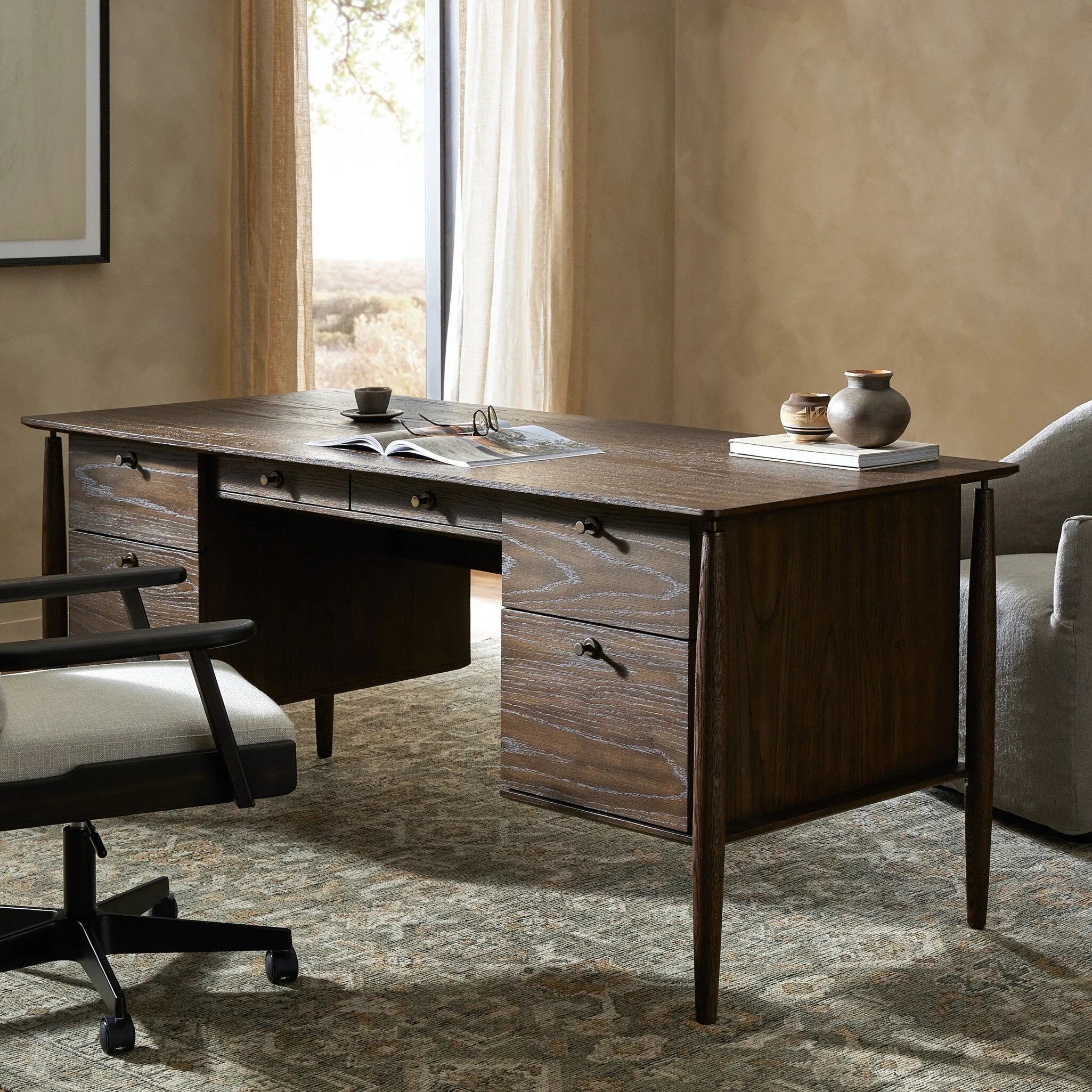 Featuring Markia Aged Oak Executive Desk by Four Hands at Amethyst Home. An executive-style desk of aged oak, inspired by European antiques. Turned, cylindrical legs adapt this charming heirloom-inspired piece for the modern home office and beyond.
Overall Dimensions: 31.0" L x 71.0 " W x 31.0" H
Collection: HaidenColors: Aged Oak Veneer ,Rubbed BronzeMateri. Amethyst Home provides interior design, new home construction design consulting, vintage area rugs, and lighting in the Monterey metro area.
