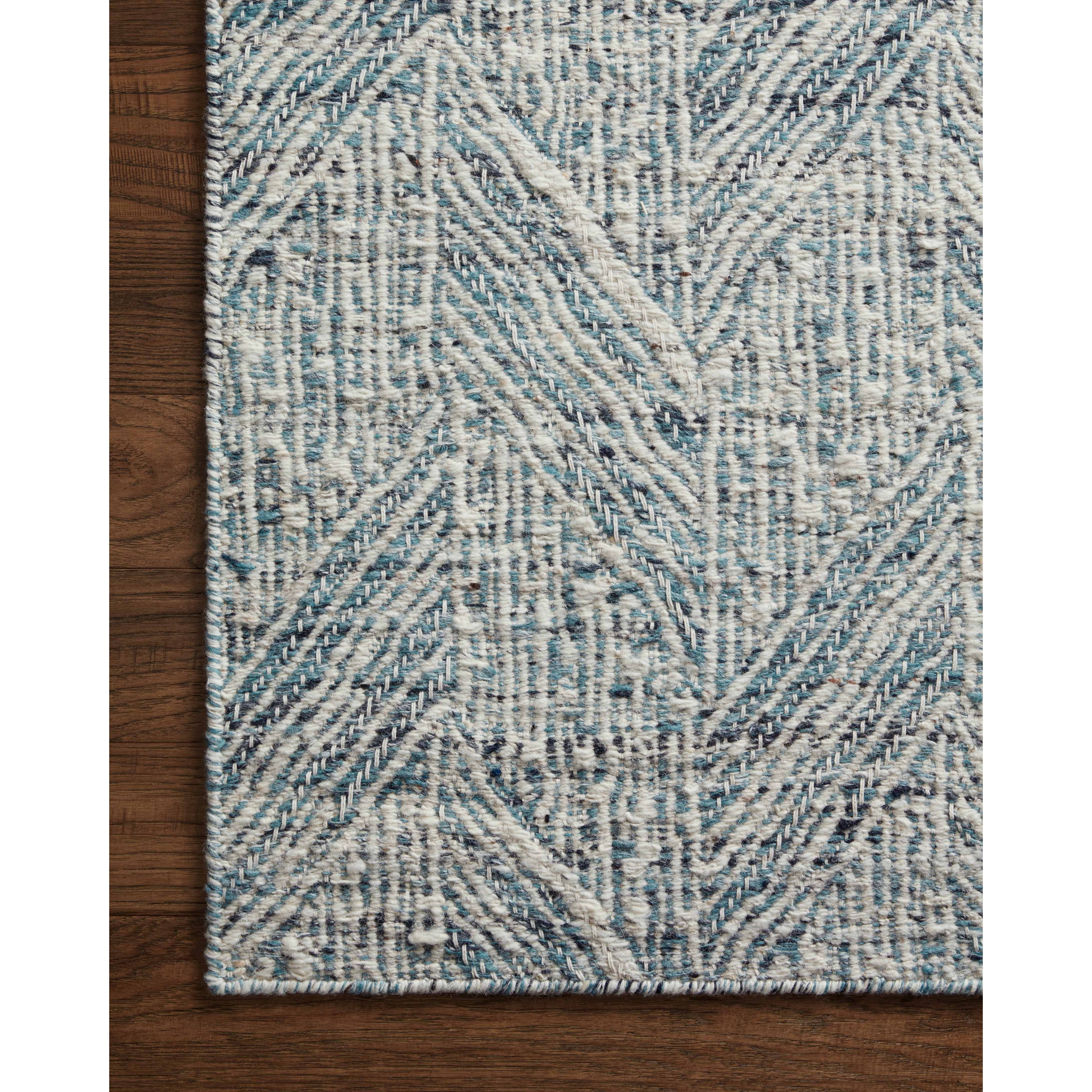 Featuring Raven Blue / Ivory Rug by Loloi at Amethyst Home. The Raven Blue / Ivory Rug is intricately handwoven with delicate, fine yarns that amplify the rug's layered and dimensional geometric design. While the rug itself is thick and sturdy, the colors and patterns have a casual lightness that can work in many spaces, from busy living rooms to serene bedrooms. The Raven Blue . Amethyst Home provides interior design, new construction, custom furniture, and area rugs in the Washington metro area.