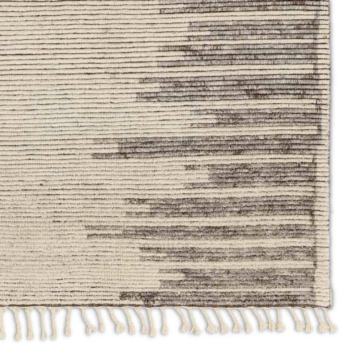 Featuring Alpine Patra Hand-Knotted Rug by Jaipur Living at Amethyst Home. Inspired by textiles from the Tullu region in Morocco, the Patra area rug showcases a linear design in neutral shades of cream, taupe, brown, and gray. This high-piled accent lends warmth and comfort to any space with durable wool hand-knotted onto a cotton foundation. Braided fringe. Amethyst Home provides interior design, new home construction design consulting, vintage area rugs, and lighting in the Charlotte metro area.