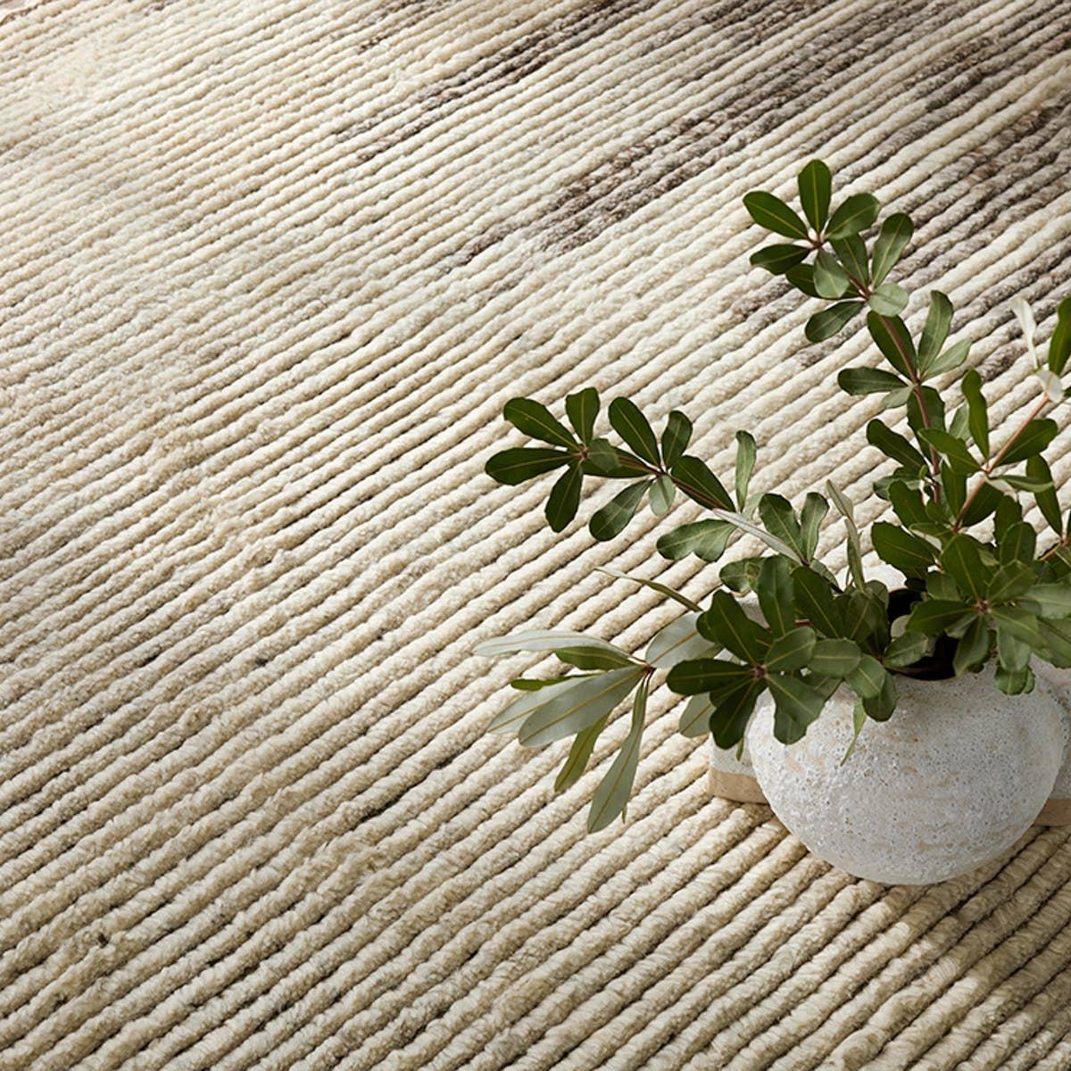 Featuring Alpine Patra Hand-Knotted Rug by Jaipur Living at Amethyst Home. Inspired by textiles from the Tullu region in Morocco, the Patra area rug showcases a linear design in neutral shades of cream, taupe, brown, and gray. This high-piled accent lends warmth and comfort to any space with durable wool hand-knotted onto a cotton foundation. Braided fri. Amethyst Home provides interior design, new home construction design consulting, vintage area rugs, and lighting in the Laguna Beach metro area.