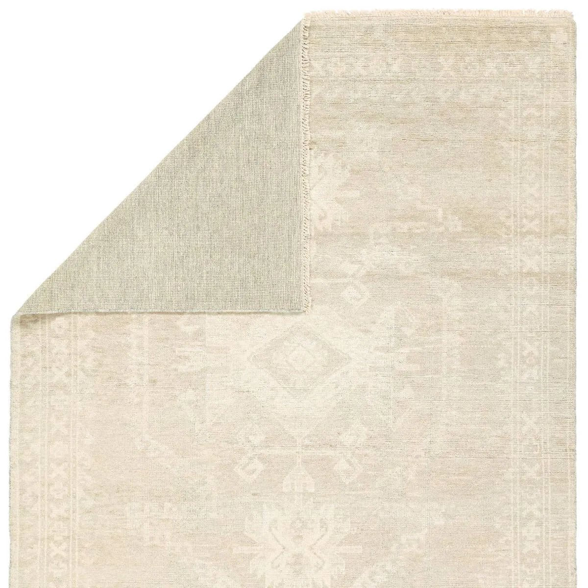 Featuring Ashend Vavite Hand-Knotted Rug by Jaipur Living at Amethyst Home. Hand carded wool, soft Tencel, and a neutral color palette define the handknotted Ashend Vavite. The Vavite rug showcases a Moroccan-inspired center medallion in a neutral cream and tan colorway. Geometric detailing establishes a thin border and provides a nod to the tribal styl. Amethyst Home provides interior design, new home construction design consulting, vintage area rugs, and lighting in the Winter Garden metro area.