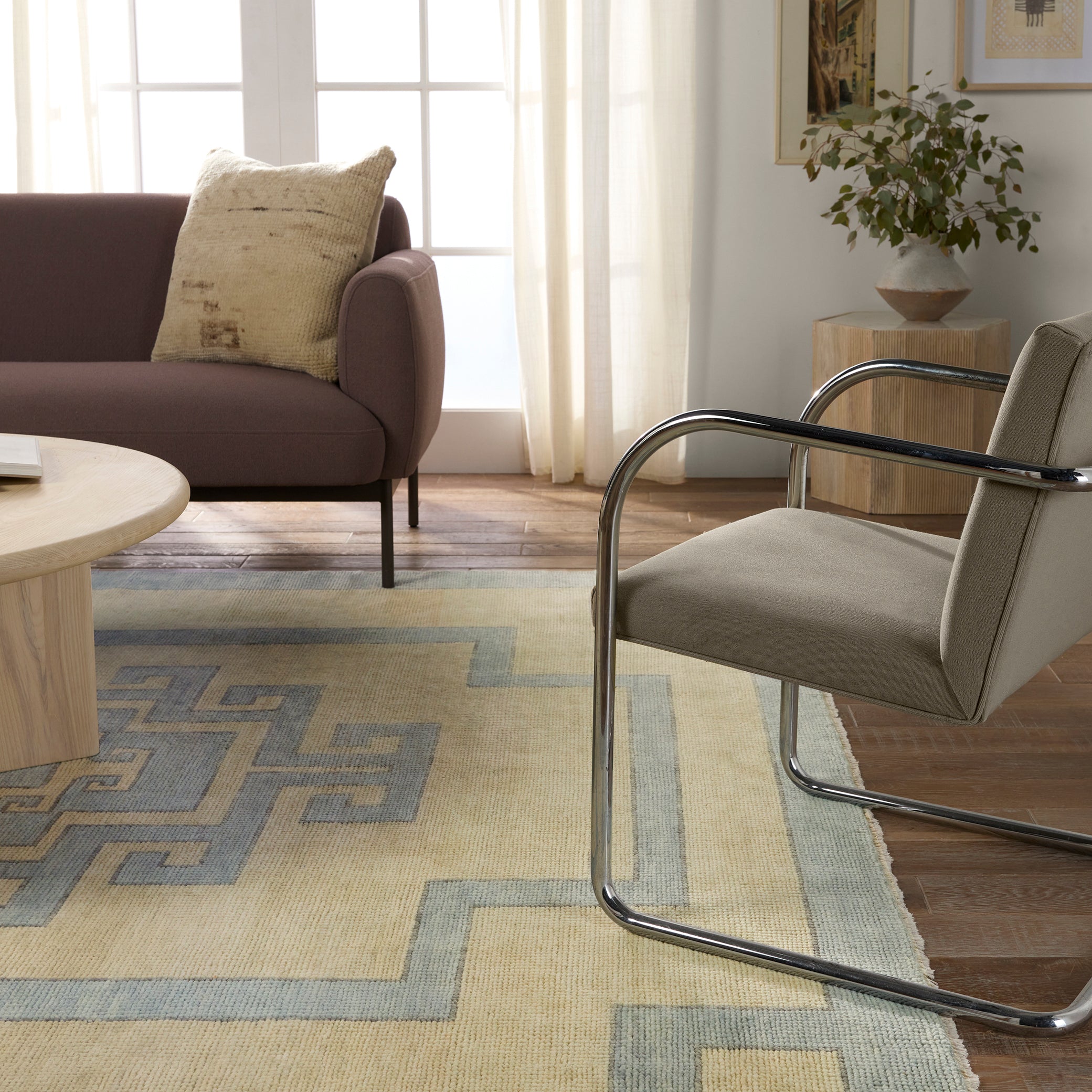 Featuring Cyprus Nicosia Asparagus Hand-Knotted Rug by Jaipur Living at Amethyst Home. The hand-knotted Cyprus collection showcases a modern representation of vintage Kars designs with clean-lined geometric details and fresh colorways. The blue, cream, gray, and caramel colored Nicosia design delights with a minimalistic medallion pattern and multiple borders. Low pile and naturally. Amethyst Home provides interior design, new construction, custom furniture, and area rugs in the Austin metro area.