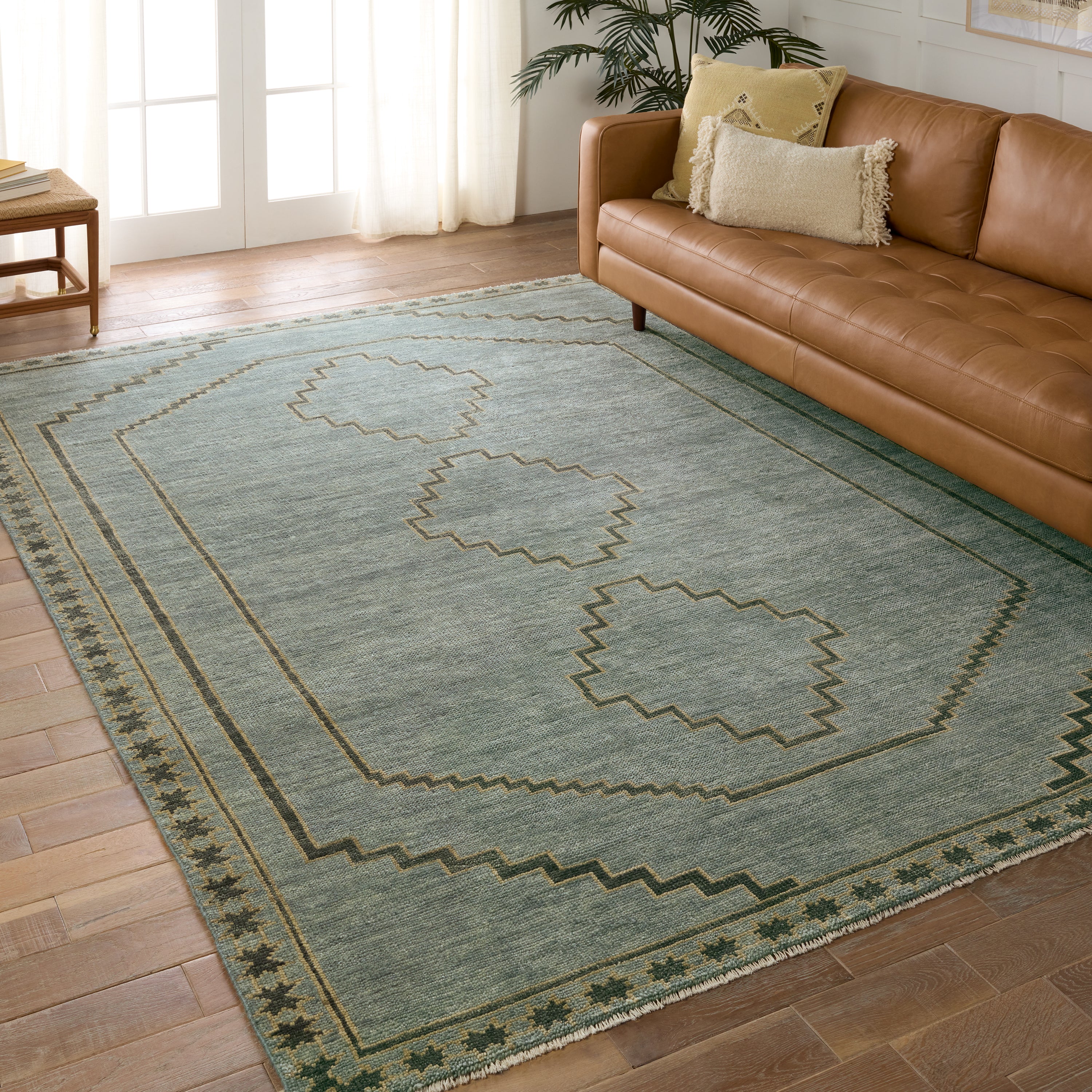 Featuring Cyprus Paphos Hand-Knotted Rug by Jaipur Living at Amethyst Home. The hand-knotted Cyprus collection showcases a modern representation of vintage Kars designs with clean-lined geometric details and fresh colorways. The blue, gray and sage green Paphos design delights with a minimalistic medallion pattern and a similarly styled border. Low pile and naturally stain resistan. Amethyst Home provides interior design, new construction, custom furniture, and area rugs in the Seattle metro area.