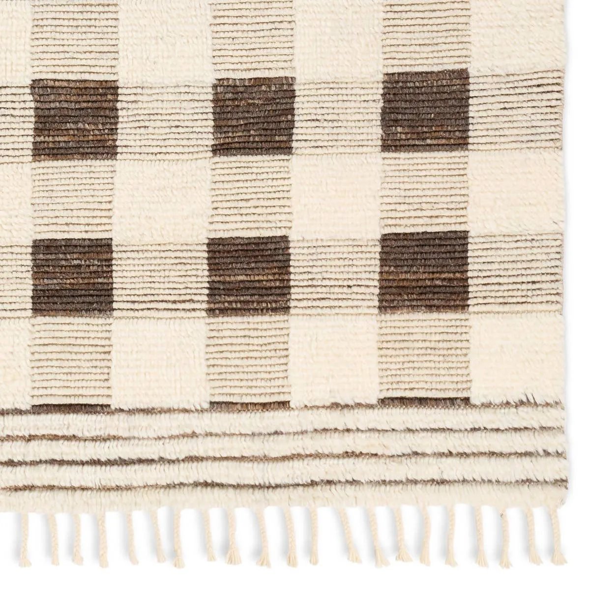 Featuring Desouk Berkshire Hand-Knotted Rug by Jaipur Living at Amethyst Home. The Desouk Berkshire melds modern allure with the global vibes of Morocco. The Berkshire hand-knotted rug showcases a geometric grid pattern with contrasting brown, cream, and tan tones. This handcrafted rug boasts plush, cut wool pile that pairs beautifully with braided tassel deta. Amethyst Home provides interior design, new home construction design consulting, vintage area rugs, and lighting in the Dallas metro area.