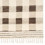 Featuring Desouk Berkshire Hand-Knotted Rug by Jaipur Living at Amethyst Home. The Desouk Berkshire melds modern allure with the global vibes of Morocco. The Berkshire hand-knotted rug showcases a geometric grid pattern with contrasting brown, cream, and tan tones. This handcrafted rug boasts plush, cut wool pile that pairs beautifully with braided tassel deta. Amethyst Home provides interior design, new home construction design consulting, vintage area rugs, and lighting in the Dallas metro area.