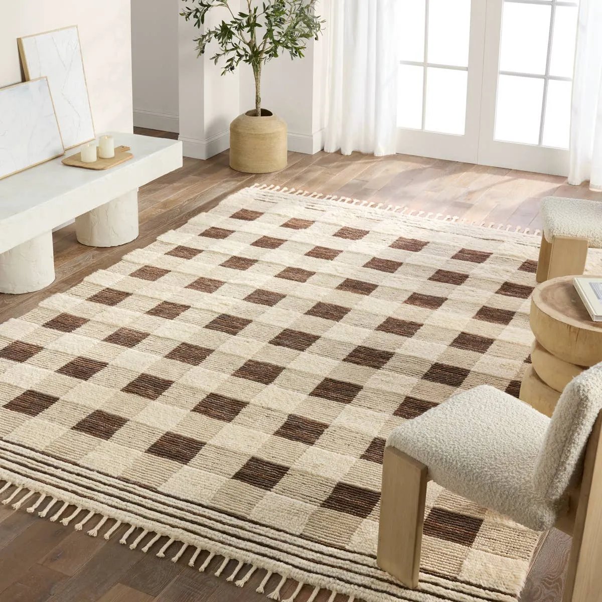 Featuring Desouk Berkshire Hand-Knotted Rug by Jaipur Living at Amethyst Home. The Desouk Berkshire melds modern allure with the global vibes of Morocco. The Berkshire hand-knotted rug showcases a geometric grid pattern with contrasting brown, cream, and tan tones. This handcrafted rug boasts plush, cut wool pile that pairs beautifully with braided tass. Amethyst Home provides interior design, new home construction design consulting, vintage area rugs, and lighting in the Newport Beach metro area.