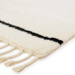 Featuring Desouk Vendace Rug by Jaipur Living at Amethyst Home. The Desouk collection melds modern allure with the global vibes of Morocco. The Vendace hand-knotted rug showcases a geometric linear pattern with contrasting black and cream tones. This handcrafted rug boasts plush, cut wool pile that pairs beautifully with braided tassel details. Perfect for adding warmth to cozy bedrooms and sit. Amethyst Home provides interior design services, furniture, rugs, and lighting in the Miami metro area.