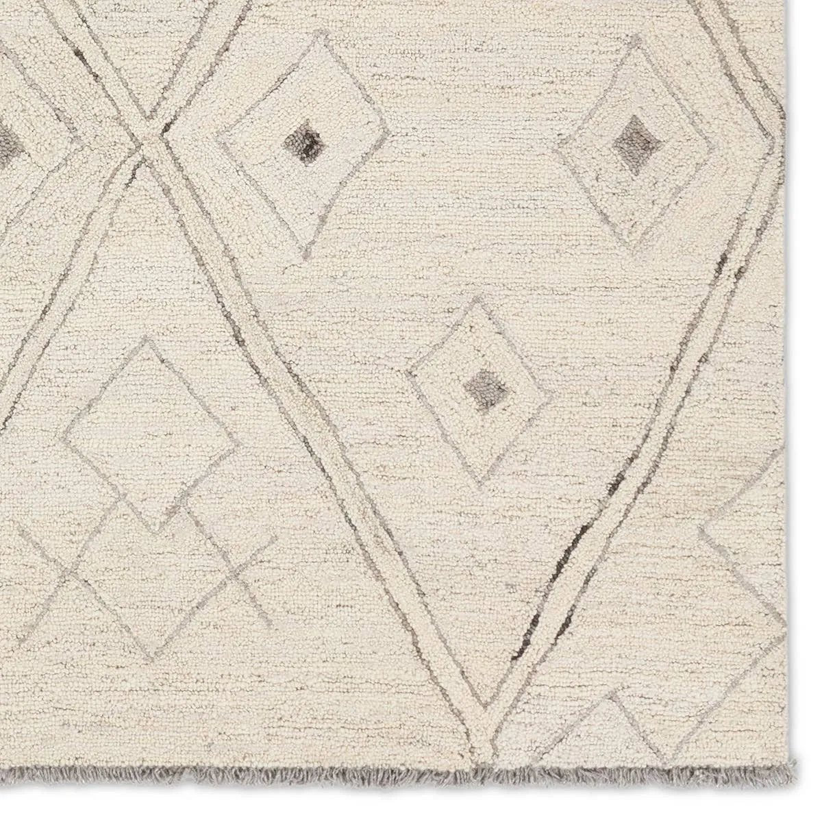 Featuring Hadi Ismael Rug by Jaipur Living at Amethyst Home. The hand-tufted Hadi Ismael introduces fresh looks inspired by modern Moroccan patterns and neutral colorways. The Ismael design features overlapping stripes in cream and gray hues. Short, gray fringe and 100% wool pile adds to the global appeal. This rug is naturally stain-resistant and works best i. Amethyst Home provides interior design, new home construction design consulting, vintage area rugs, and lighting in the Boston metro area.