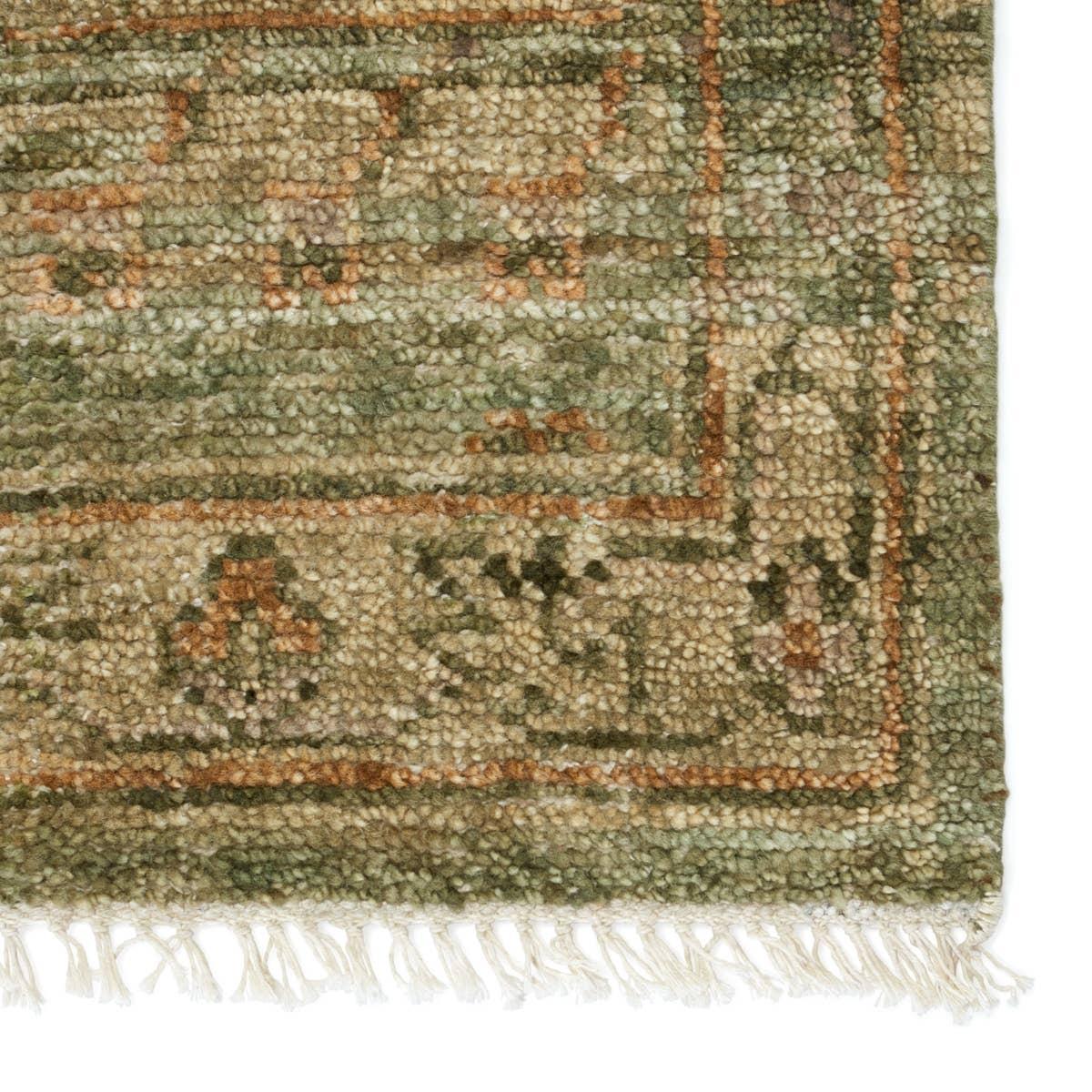 Featuring Jinsen Augusta Hand-Knotted Rug by Jaipur Living at Amethyst Home. The hand-knotted Jinsen Augusta features a fresh incarnation of the vintage Turkish textile look. Classic in pattern and modern in color, the Augusta rug boasts a beautiful palette of green, burnished gold, and hints of taupe featuring distinct dye-lot details and subtle fringe. Th. Amethyst Home provides interior design, new home construction design consulting, vintage area rugs, and lighting in the Charlotte metro area.
