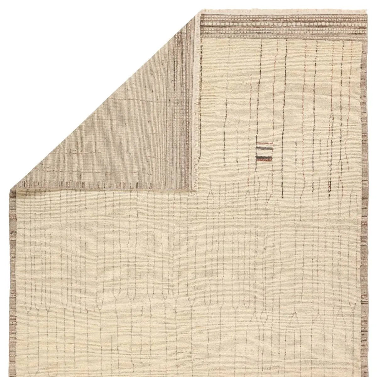 Featuring Kazben Atalaya Hand-Knotted Rug by Jaipur Living at Amethyst Home. Full of texture, the handknotted Kazben Atalaya stuns with modern Moroccan patterns in natural hues. The Atalaya design delights with a gray and brown abstract-linear pattern on a cream base. A dotted border adds the finishing touches to this elevated accent piece. Low, ribbed pile. Amethyst Home provides interior design, new home construction design consulting, vintage area rugs, and lighting in the Charlotte metro area.