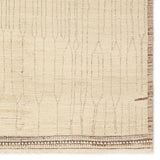 Featuring Kazben Atalaya Hand-Knotted Rug by Jaipur Living at Amethyst Home. Full of texture, the handknotted Kazben Atalaya stuns with modern Moroccan patterns in natural hues. The Atalaya design delights with a gray and brown abstract-linear pattern on a cream base. A dotted border adds the finishing touches to this elevated accent piece. Low, ribbed pile cr. Amethyst Home provides interior design, new home construction design consulting, vintage area rugs, and lighting in the Dallas metro area.