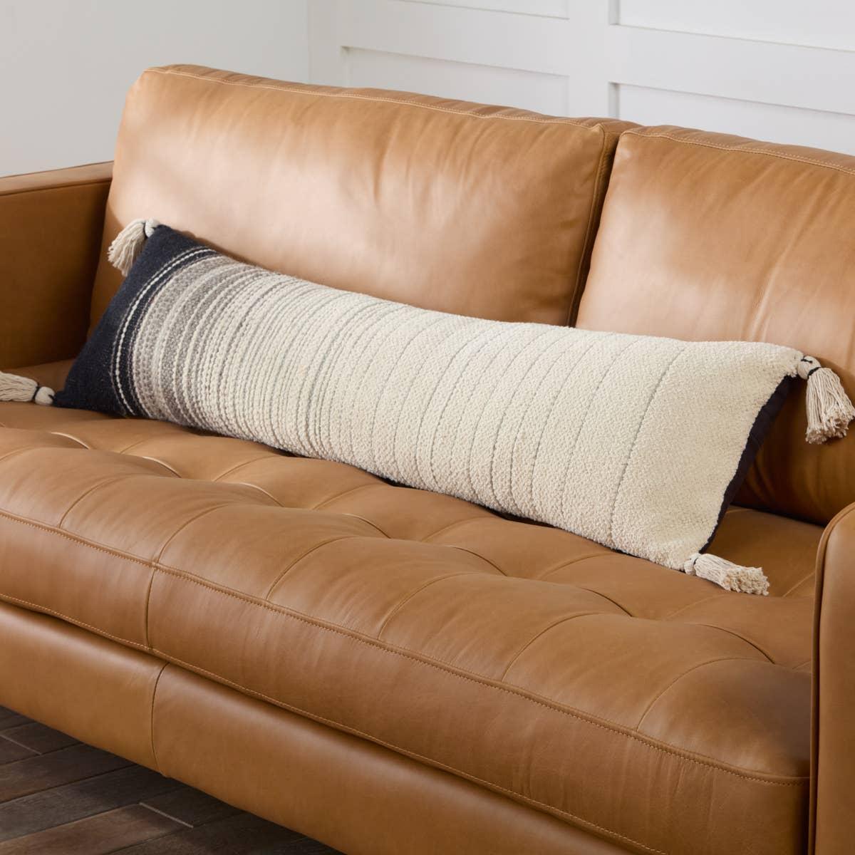 Featuring Mercado Sabir Pillow by Jaipur Living at Amethyst Home. The Mercado pillow Sabir marries bohemian charm and irresistible texture. The Sabir lumbar pillow offers a warm and cozy accent to modern spaces with a versatile, striped design and bohemian-style corner tassels. Crafted of soft cotton, this plush accent's light gray, white, and black heather. Amethyst Home provides interior design, new home construction design consulting, vintage area rugs, and lighting in the Nashville metro area.