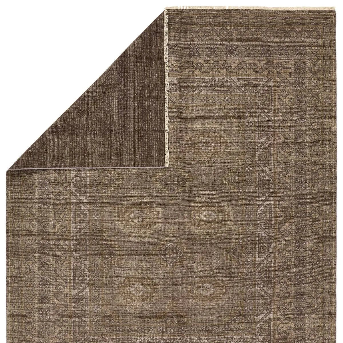 Featuring Rhapsody Kortan Hand-Knotted Rug by Jaipur Living at Amethyst Home. The Rhapsody Kortan features heirloom-quality designs of stunningly abrashed Old World patterns. The Kortan area rug boasts a beautifully distressed mini-medallion motif with a decorative, multi-layered border and geometric detailing. The brown, cream, and tan hues add depth and i. Amethyst Home provides interior design, new home construction design consulting, vintage area rugs, and lighting in the Nashville metro area.
