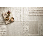 Featuring Manfred Ivory / Pebble Hand-Knotted Rug by Loloi at Amethyst Home. Each area rug in the Manfred Ivory / Pebble rug collection is meticulously hand-knotted with a technique that creates a high-low texture, adding visual depth and movement. The rug’s patchwork design is casually sophisticated, fitting into living rooms, bedrooms, and dens—anywhe. Amethyst Home provides interior design, new home construction design consulting, vintage area rugs, and lighting in the Winter Garden metro area.