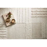 Featuring Manfred Ivory / Pebble Hand-Knotted Rug by Loloi at Amethyst Home. Each area rug in the Manfred Ivory / Pebble rug collection is meticulously hand-knotted with a technique that creates a high-low texture, adding visual depth and movement. The rug’s patchwork design is casually sophisticated, fitting into living rooms, bedrooms, and dens—anywhe. Amethyst Home provides interior design, new home construction design consulting, vintage area rugs, and lighting in the Winter Garden metro area.