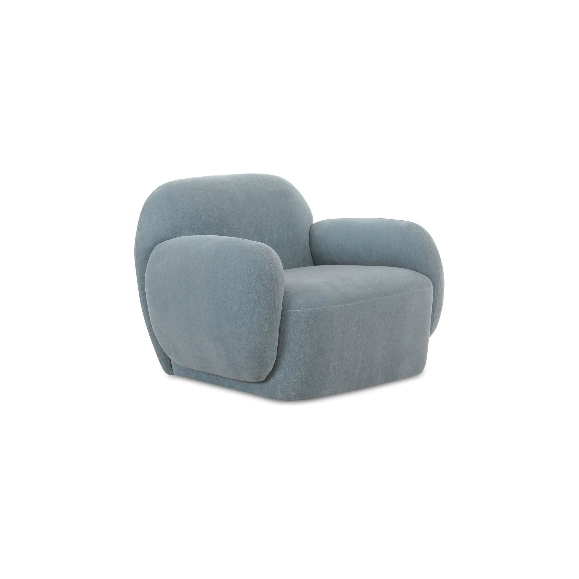 The Hazel lounge chair embraces minimalist, understated elegance with its low-profile, modernist silhouette. Wrapped in exaggerated  velvet fabric, it offers a distinct tactility and comfort. The bold, curved arm design makes a stylish statement, harmonizing with the sleek form to create an inviting focal point in any setting Amethyst Home provides interior design, new home construction design consulting, vintage area rugs, and lighting in the Portland metro area.