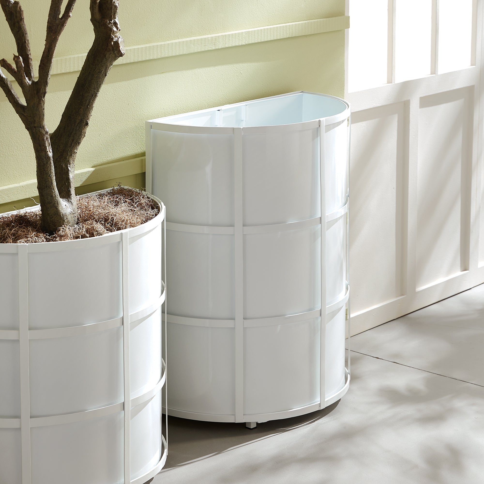 Raised off the ground for proper drainage, this well-scaled demilune planter is the modern interpretation of an antique planter. It is fully powder-coated, and has a removable liner with recessed handles. A statement piece for between windows, garage doors and onpatio. Amethyst Home provides interior design, new construction, custom furniture, and area rugs in the Austin metro area.