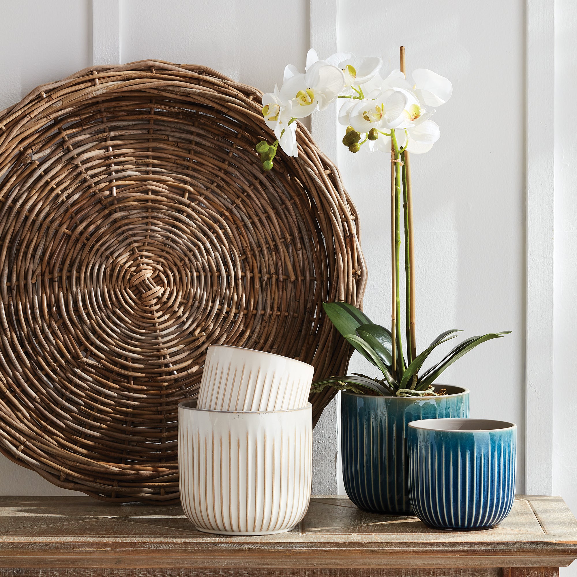 Made of a large gauge rattan, these large scale trays make for a beautiful centerpiece. Fill them with orbs, faux flower stems or leave just as is for a clean look. Amethyst Home provides interior design, new construction, custom furniture, and area rugs in the Miami metro area.
