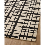 Featuring Polly Chris Loves Julia x Loloi Black / Ivory Rug by Loloi at Amethyst Home. Hand-tufted of wool and jute pile, the Polly Black / Ivory rug for Chris Loves Julia x Loloi brings a fresh take on modern yet classic designs. With striking gridded designs toned down by a neutral color palette, Polly is a timeless choice for any room. Polly is also GoodWeave certified, ensuring . Amethyst Home provides interior design, new construction, custom furniture, and rugs for the Des Moines metro area.