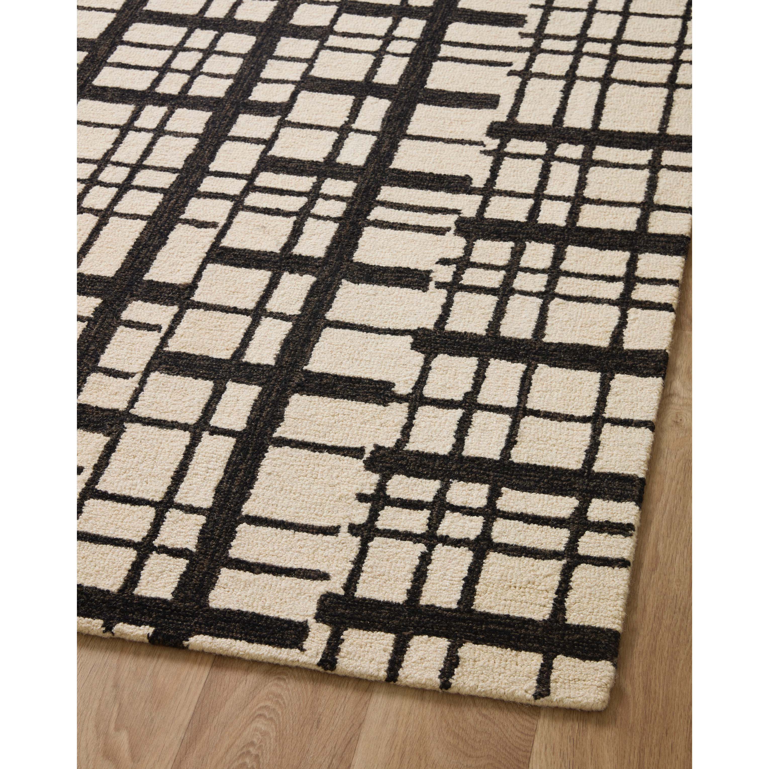 Featuring Polly Chris Loves Julia x Loloi Black / Ivory Rug by Loloi at Amethyst Home. Hand-tufted of wool and jute pile, the Polly Black / Ivory rug for Chris Loves Julia x Loloi brings a fresh take on modern yet classic designs. With striking gridded designs toned down by a neutral color palette, Polly is a timeless choice for any room. Polly is also GoodWeave certified, ensuring . Amethyst Home provides interior design, new construction, custom furniture, and rugs for the Des Moines metro area.