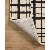 Featuring Polly Chris Loves Julia x Loloi Black / Ivory Rug by Loloi at Amethyst Home. Hand-tufted of wool and jute pile, the Polly Black / Ivory rug for Chris Loves Julia x Loloi brings a fresh take on modern yet classic designs. With striking gridded designs toned down by a neutral color palette, Polly is a timeless choice for any room. Polly is also GoodWeave certified, ensuring o. Amethyst Home provides interior design, new construction, custom furniture, and rugs for the Nashville metro area.