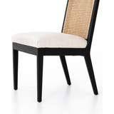 Featuring Antonia Cane Brushed Ebony Armless Dining Chair by Four Hands at Amethyst Home. We love the retro style the natural cane of this Antonia Cane Brushed Ebony Armless Dining Chair brings to a dining room. 
Overall Dimensions: 22.25"W x 23.50"L x 33"HColors: Light Natural Cane, Brushed Ebony, Savile FlaxMaterials: Cane, Solid Nettlewood, 92% Pl, 8% LiFab.  Amethyst Home provides interior design, new home construction design consulting, vintage area rugs, and lighting in the Miami metro area.