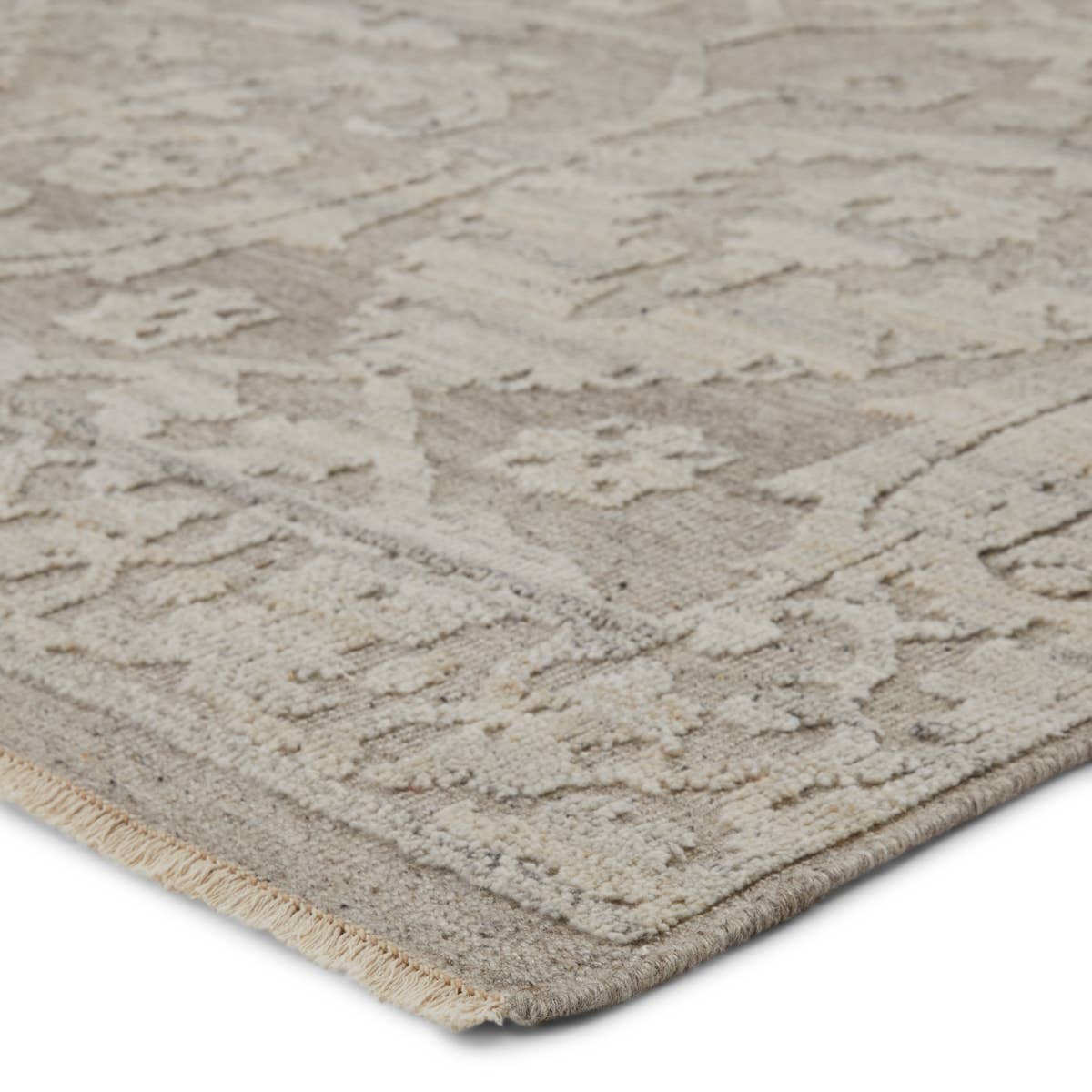 Featuring Sonnette Ayres Hand-Knotted Rug by Jaipur Living at Amethyst Home. The richly textured and elegantly designed Sonnette Ayres Area Rug combines an inviting, soft hand and eye-catching transitional style. The Ayres rug boasts a neutral palette of light taupe and gray that creates beautiful dimension among the brocade design. This hand-knotted wool.  Amethyst Home provides interior design, new home construction design consulting, vintage area rugs, and lighting in the Alpharetta metro area.