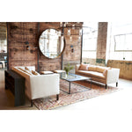 Featuring Stewart Sofa by Cisco Brothers at Amethyst Home. The Stewart Sofa by Cisco Brothers has a simple silhouette with striking angles and trim wooden accent legs. The wide bench cushion provides ample seating space ideal for entertaining. Pop some popcorn and pile on the throw pillows for cozy movie nights with the family. Photographed in Vintage Flax. .  Amethyst Home provides interior design, new home construction design consulting, vintage area rugs, and lighting in the Houston metro area.
