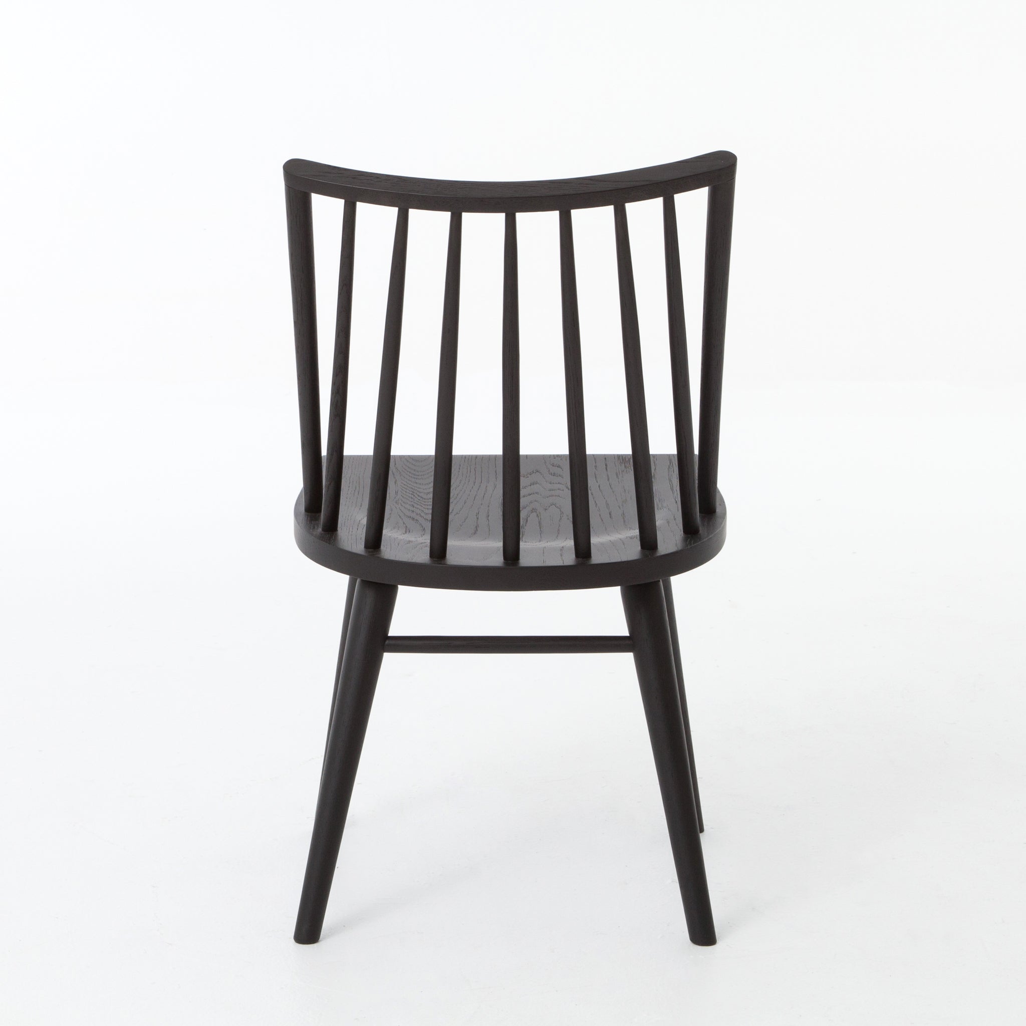 Featuring Windsor Black Oak Dining Chair by Four Hands at Amethyst Home. Try a cleaner, more modern take on the traditional Windsor with our Windsor Dining Chair. This tall beauty is wire-brushed to bring out the cathedral grain in the oak, and stained deep black for lovely contrast with more industrial decor. This chair is super comfortable and perfect .  Amethyst Home provides interior design, new home construction design consulting, vintage area rugs, and lighting in the Kansas City metro area.