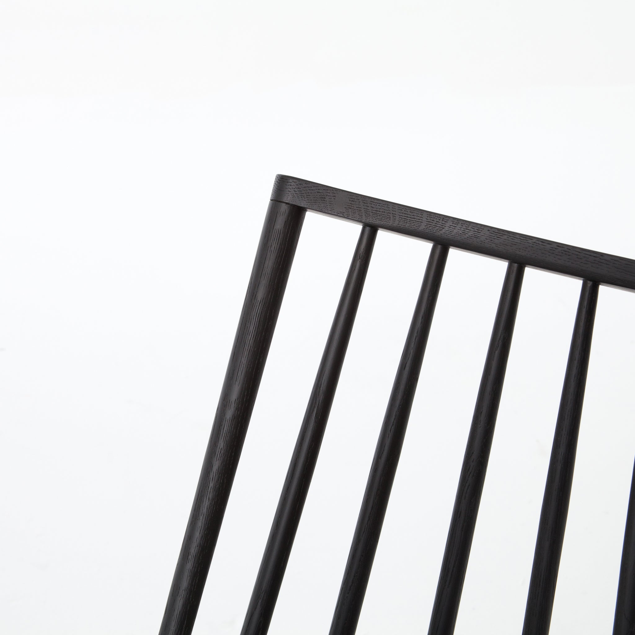 Featuring Windsor Black Oak Dining Chair by Four Hands at Amethyst Home. Try a cleaner, more modern take on the traditional Windsor with our Windsor Dining Chair. This tall beauty is wire-brushed to bring out the cathedral grain in the oak, and stained deep black for lovely contrast with more industrial decor. This chair is super comfortable and perfect.  Amethyst Home provides interior design, new home construction design consulting, vintage area rugs, and lighting in the Laguna Beach metro area.