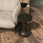 Made from raw black cast aluminum, a dramatically tapered Gino End Table - Raw Black flaunts beautiful high/ low hues and subtle Brutalist vibes. Perfect for setting your book or favorite drink next to.   Overall Dimensions: 13.00"w x 13.00"d x 20.00"h